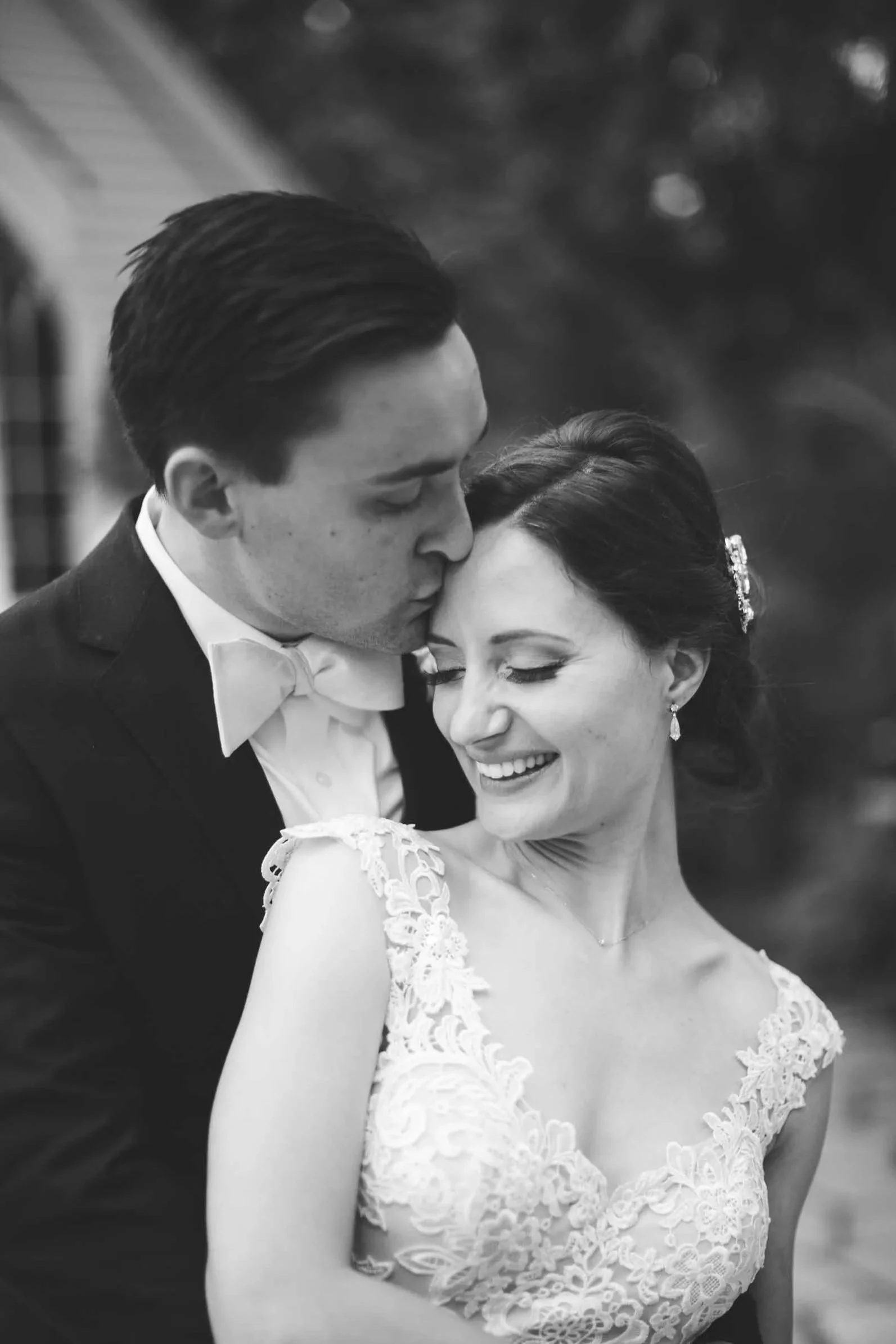 Black and White Wedding Portrait at The Doctor’s House – Groom Kissing Bride’s Forehead