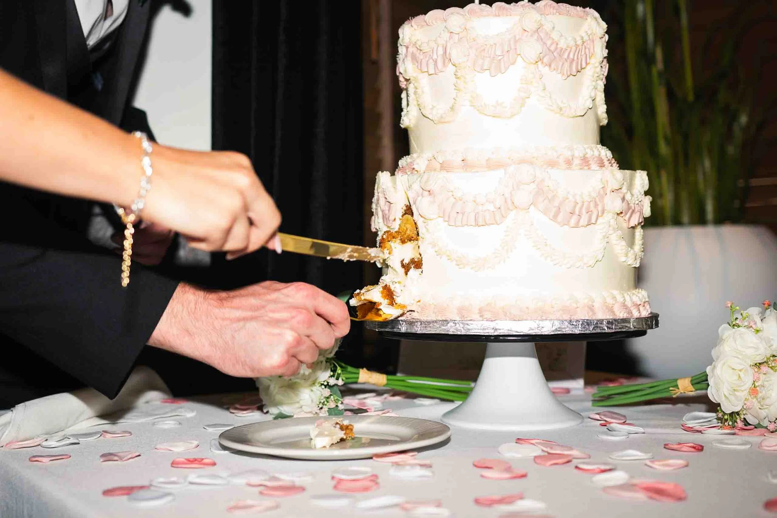 Bride and groom cutting the cake at charcoal steak house in kitchener ontario.