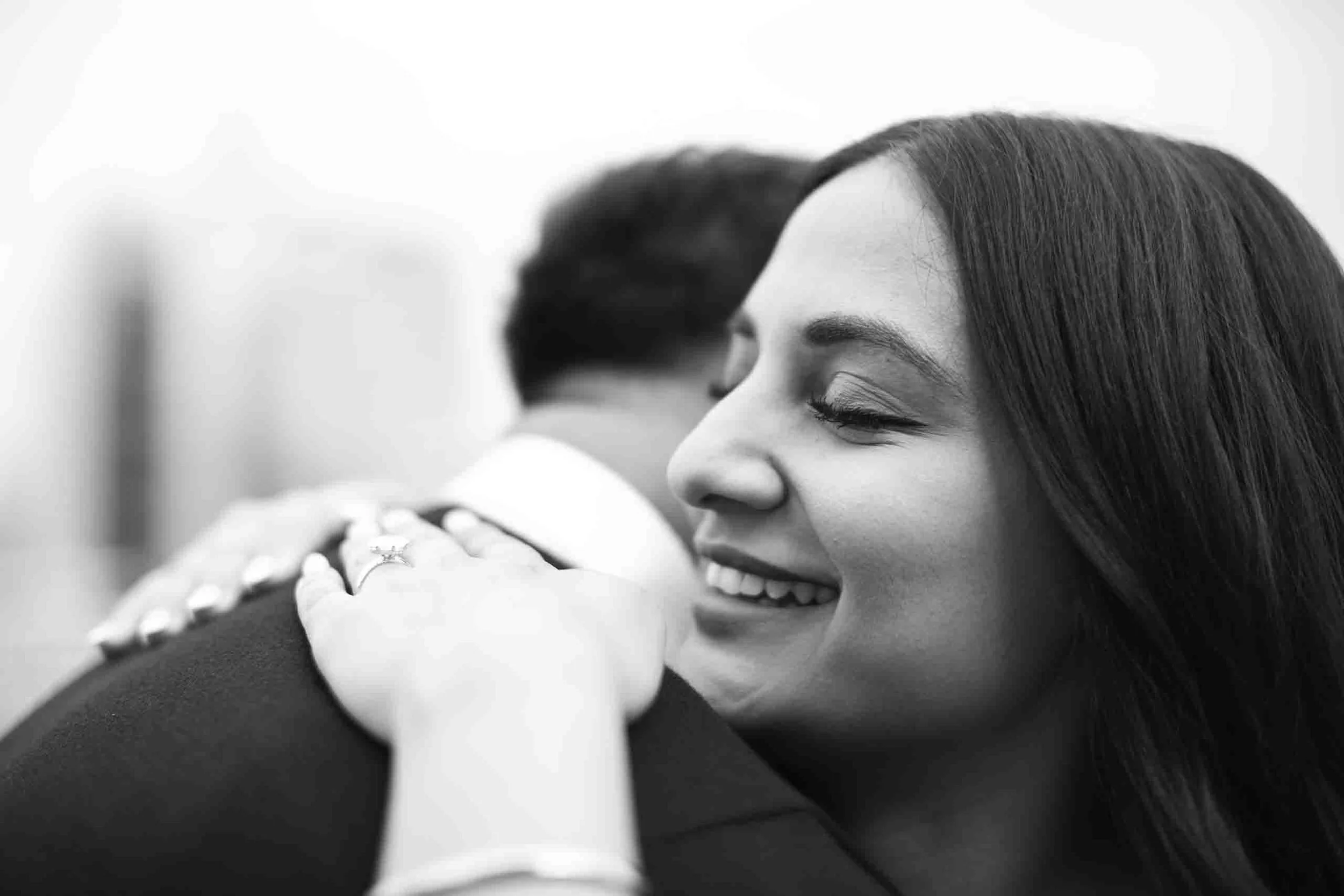 bride hugging groom after saying yes to the surprise proposal engagement shoot in downtown toronto.