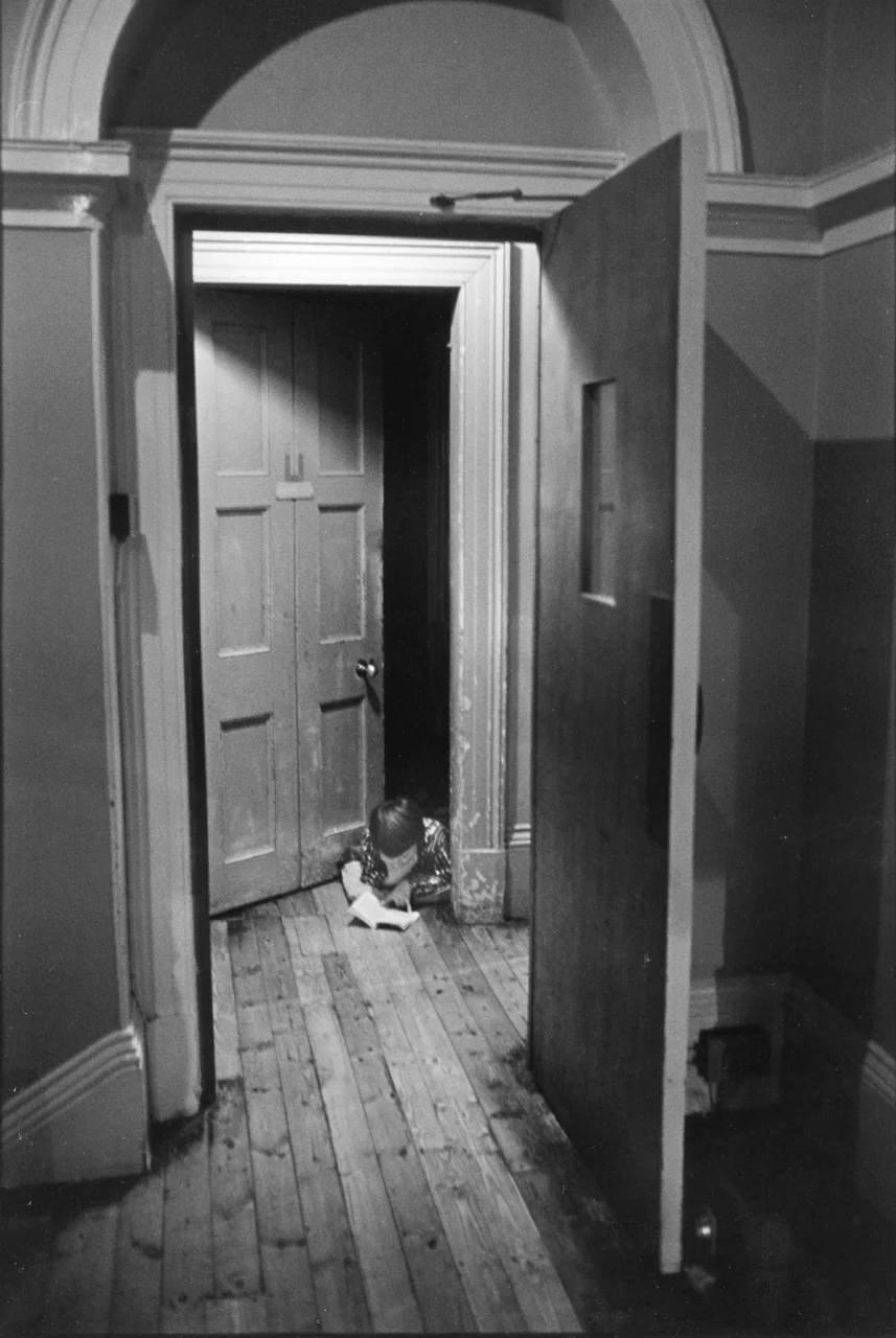 Reading in the hallway.