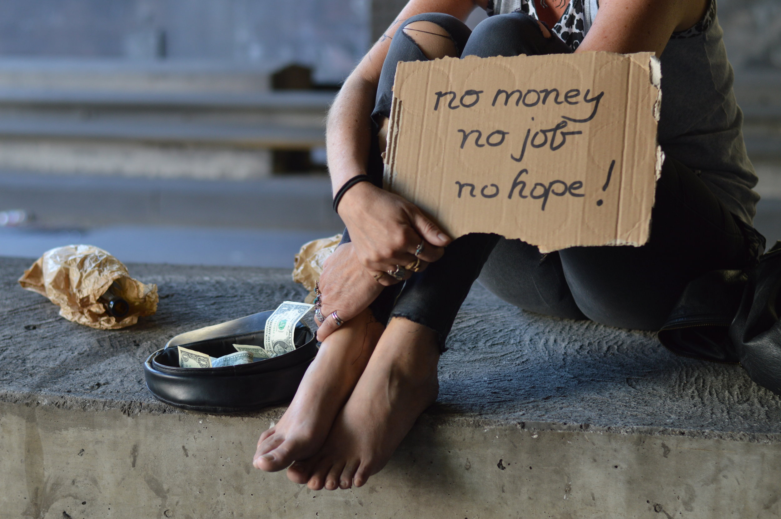 homeless woman with sign.jpeg