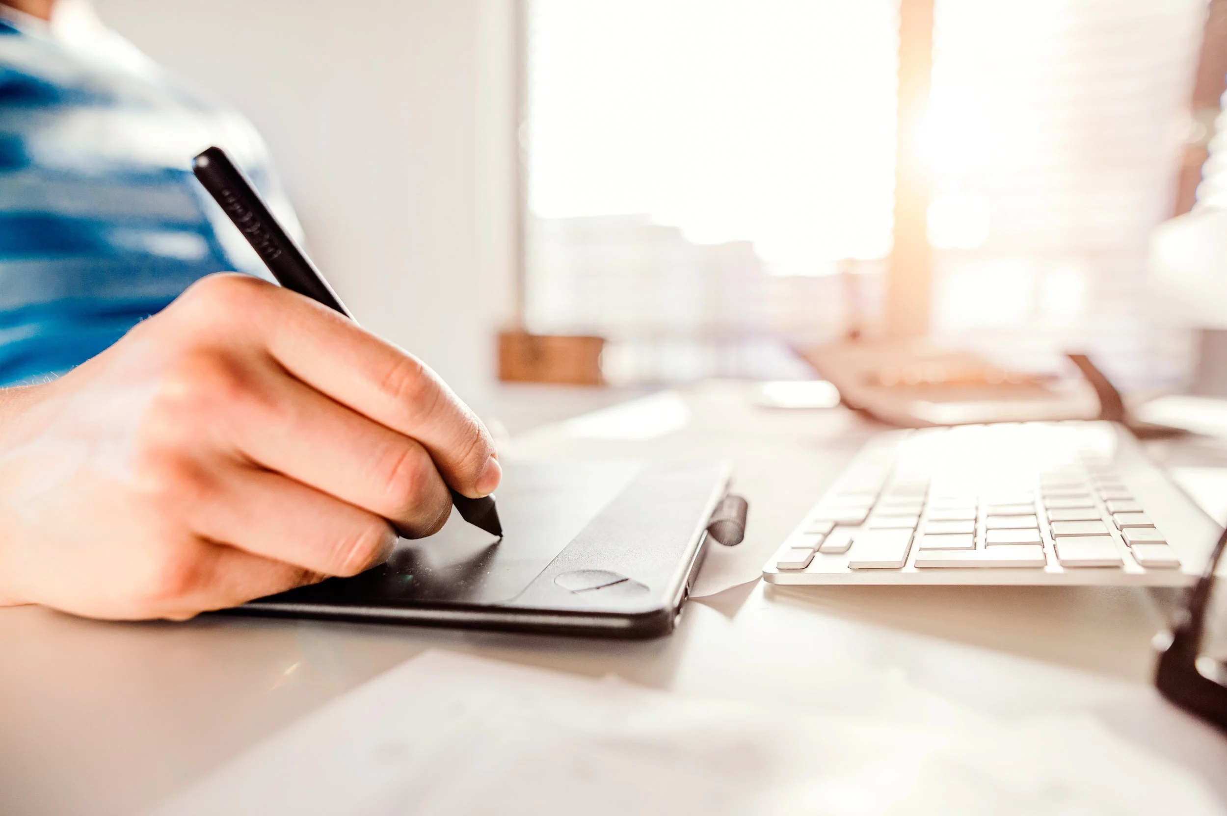 graphicstock-hand-of-unrecognizable-man-working-from-home-writing-on-graphic-tablet_Sup7dSSGZ.jpg