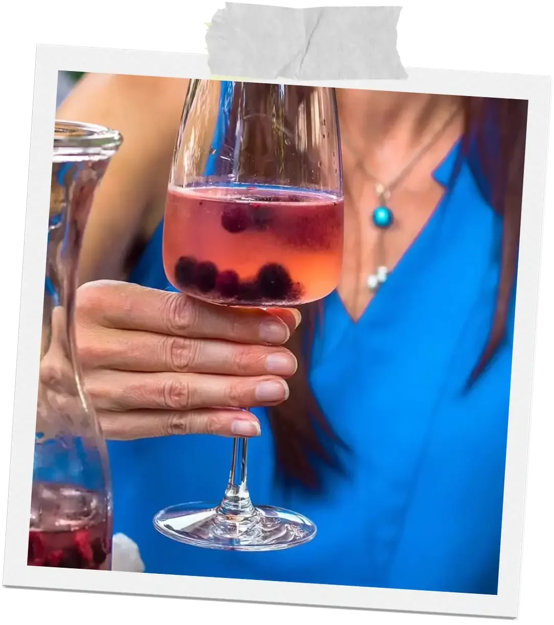 A guest holding a glass of rosé wine at La Dolce Vita, capturing a relaxed and social dining moment in Ottawa.