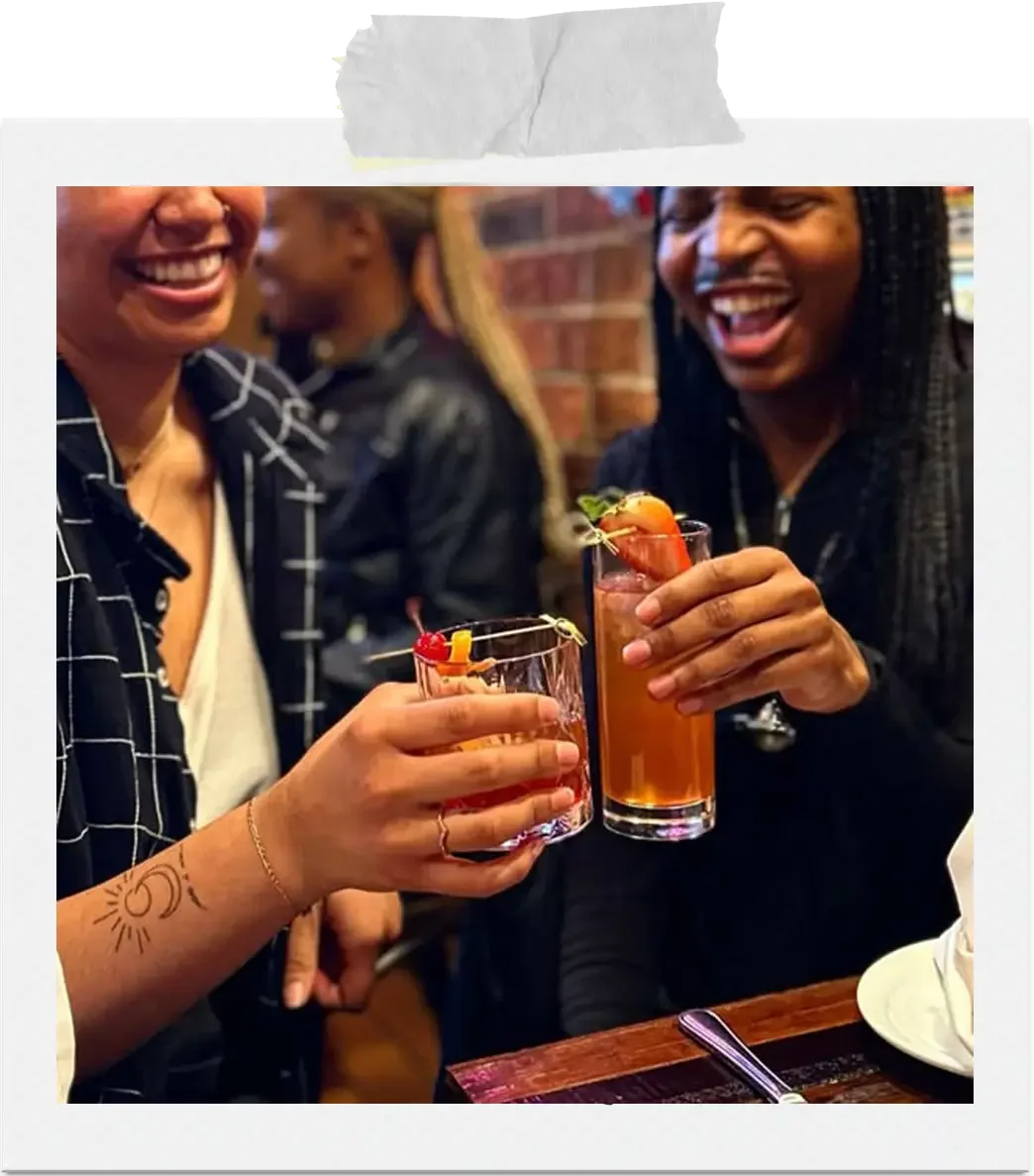 Guests sharing cocktails and raising glasses during a relaxed evening at La Dolce Vita restaurant in Ottawa.