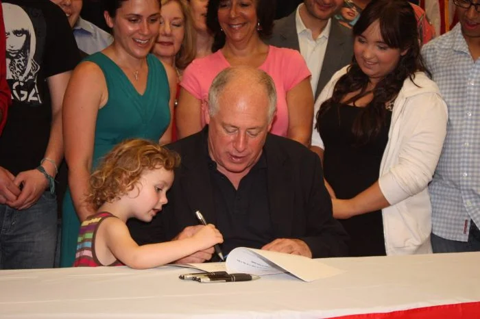 Illinois Governor Pat Quinn signs the Prevent School Violence Act into law. Behind, stands Founding Alliance Executive Director, Shannon Sullivan, and Alliance Youth Committee Members who advocated for the bill's passage. 