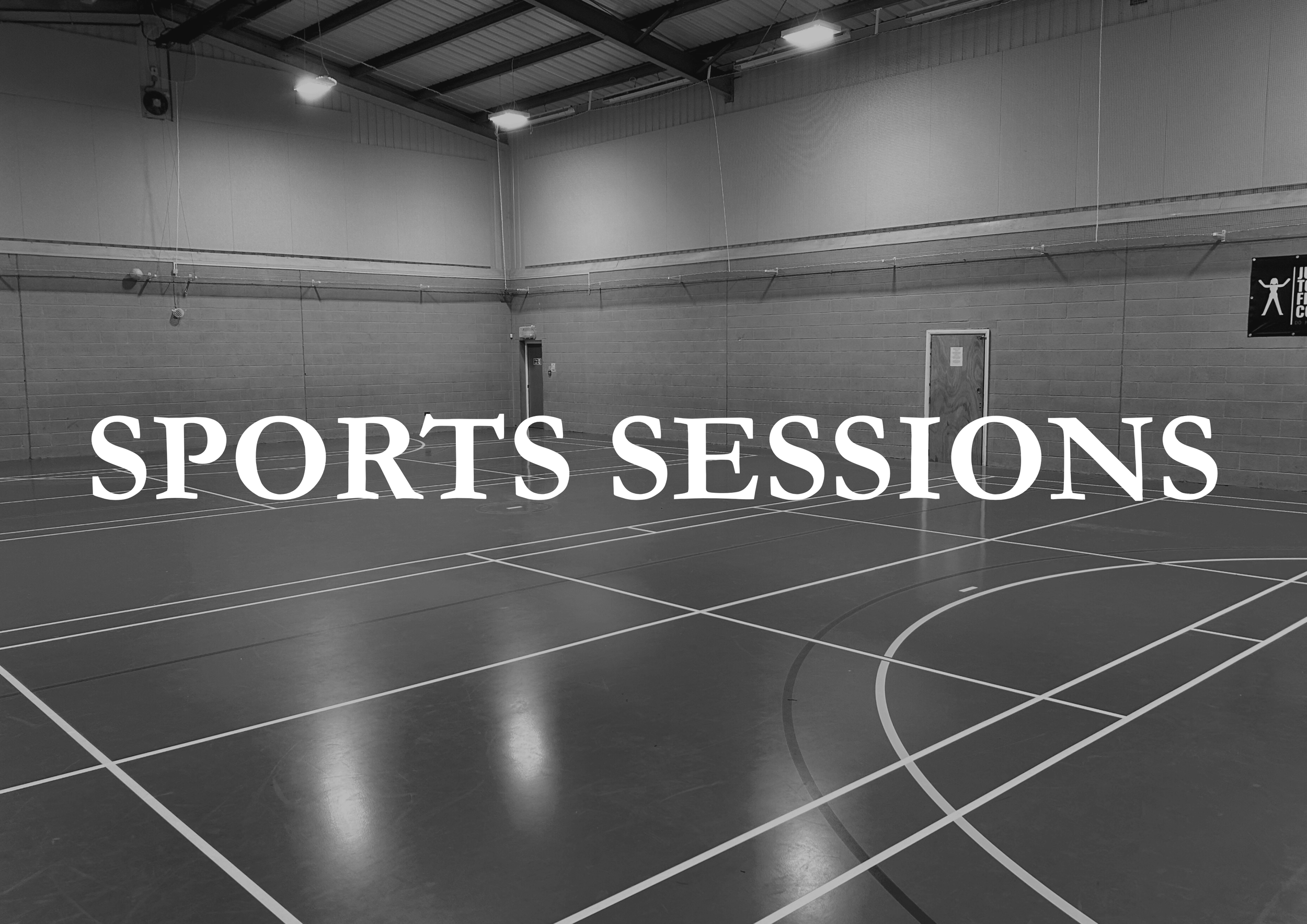 Empty indoor sports court with lines and a sign on the wall indicating sports activities.