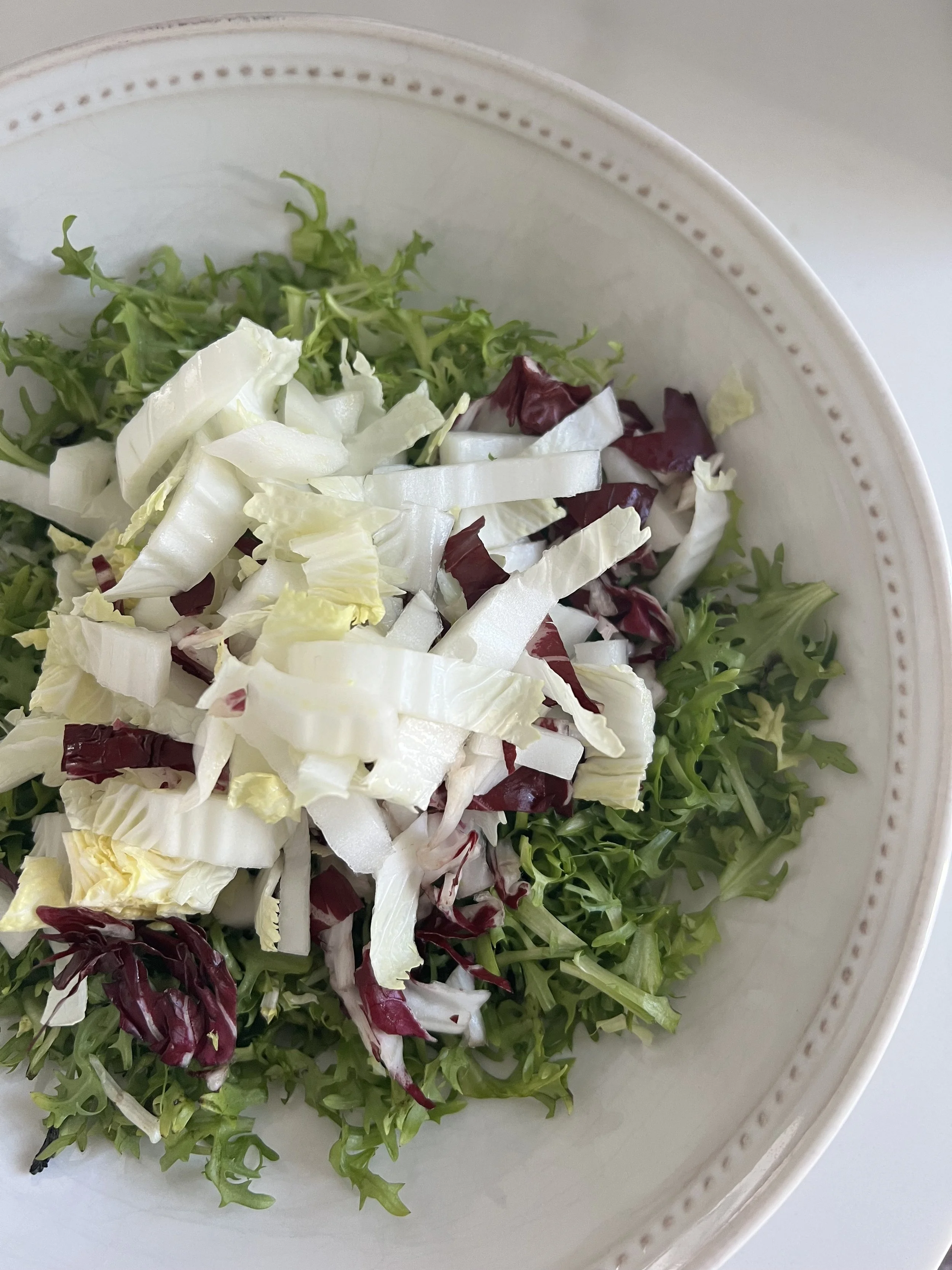 Fresh organic frisee, nappa cabbage and radicchio salad