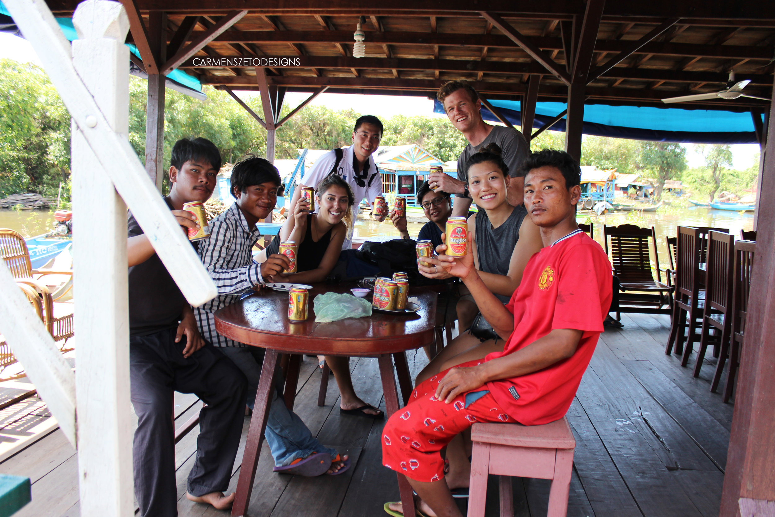Our local guides at the Tonle Sap floating village and our friends that works with GoPro we met on the same trip enjoying crocodile and beer!