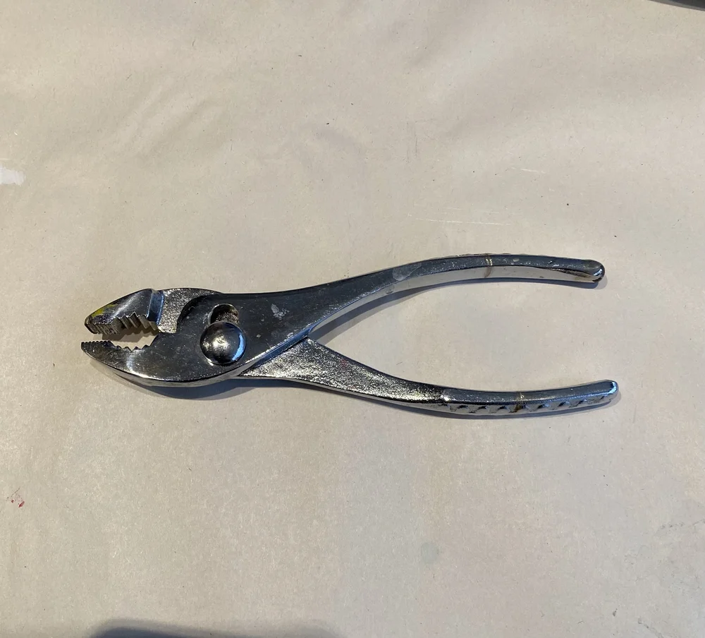 Pliers to open stubborn paint lids