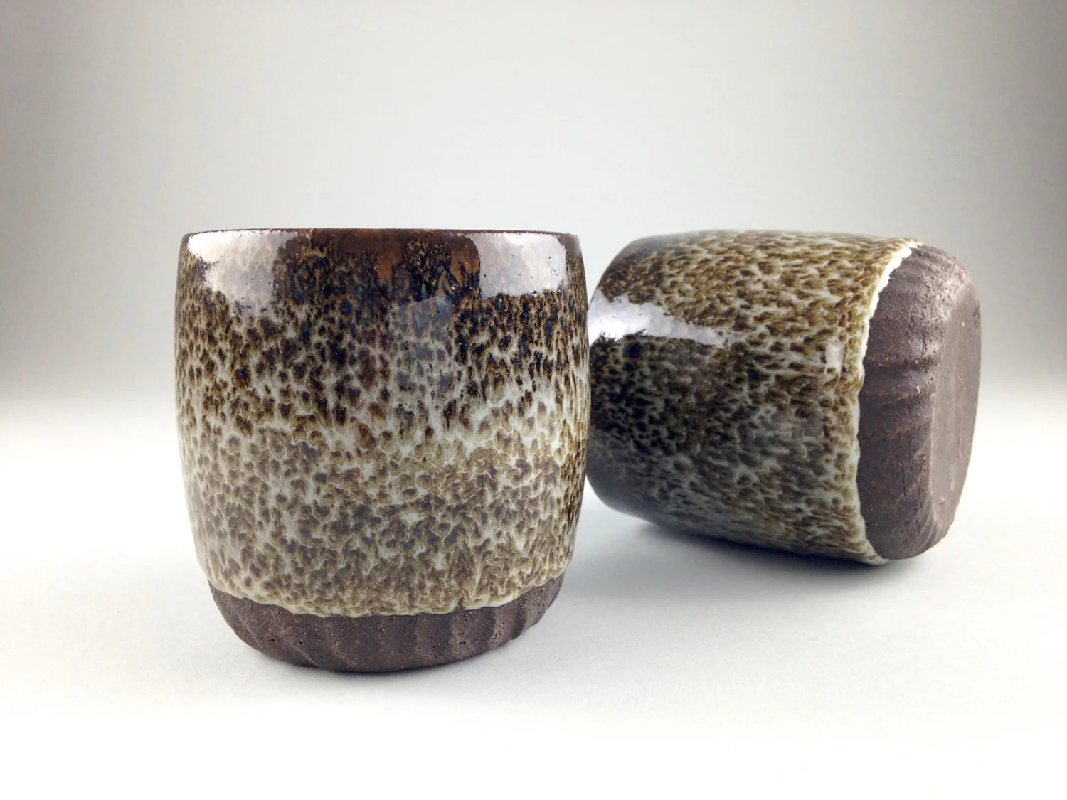 Stoneware tumblers, faux oilspot glaze