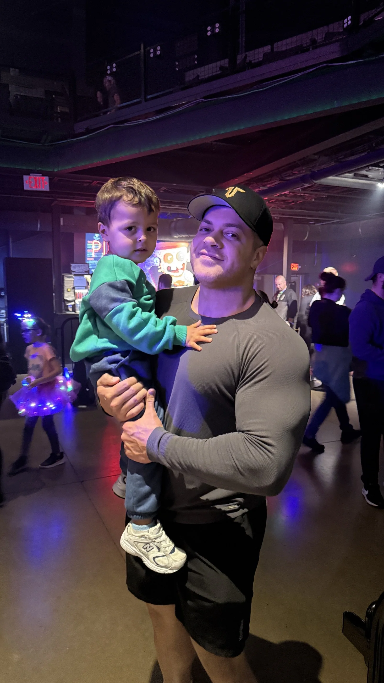 Jordan Coleman, online fitness coach in Columbus, Ohio, holding his son Calvin