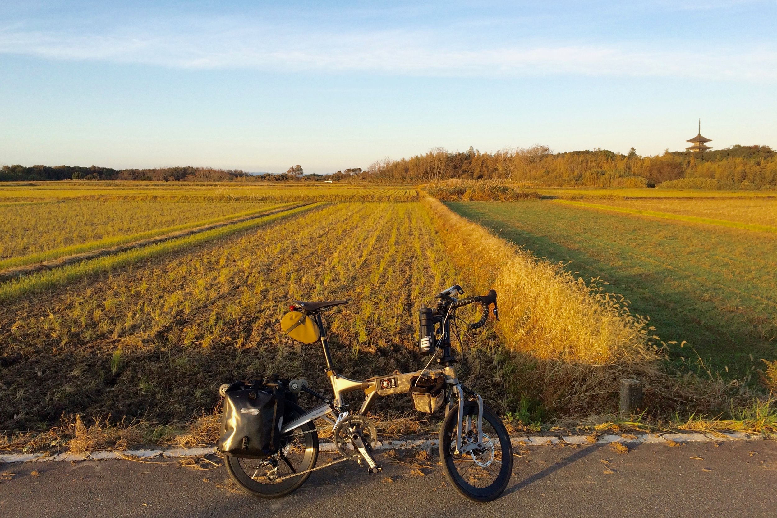 Crossing the countryside, with the Myojoji temple pagoda visible in the background.