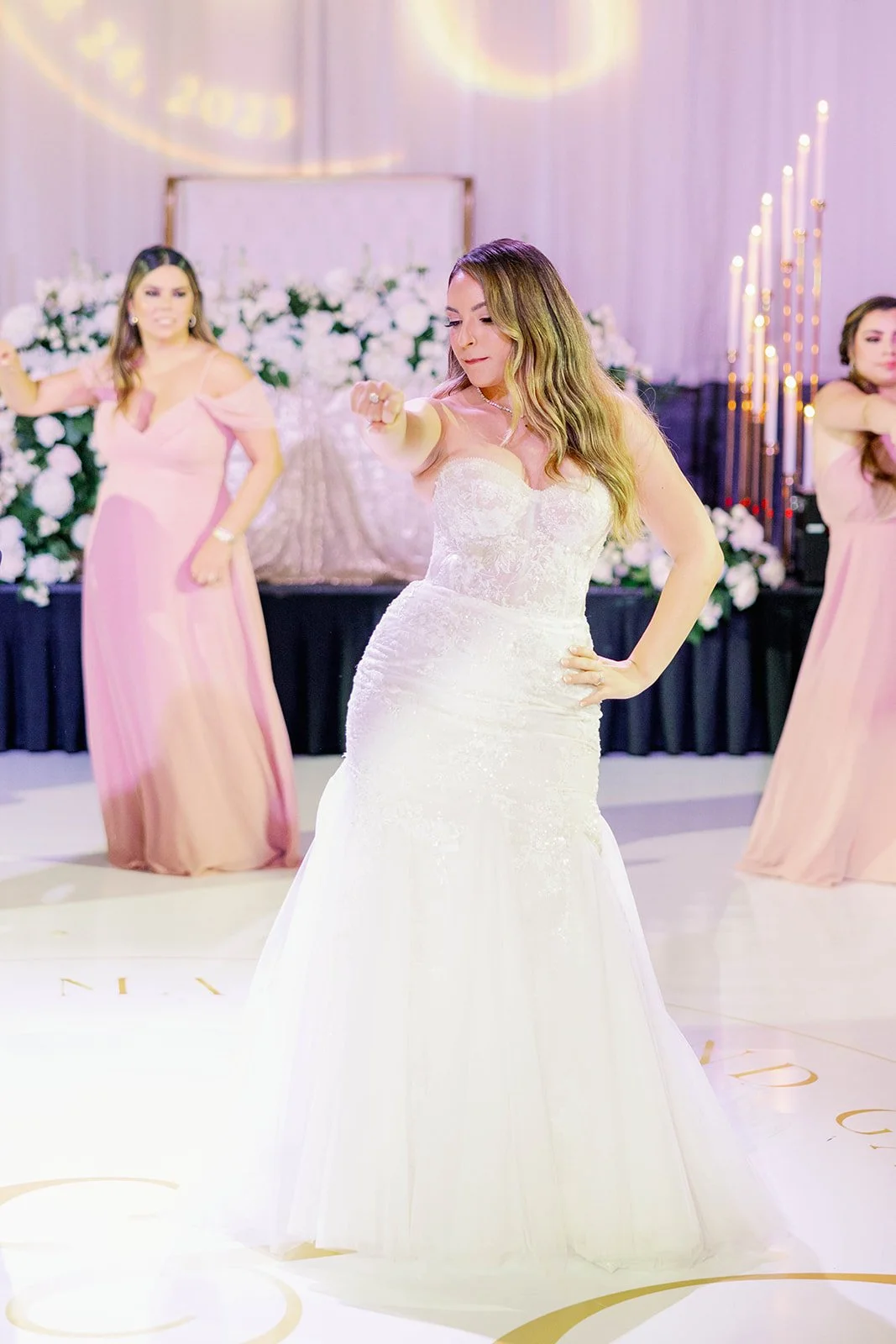 Family and friends dancing together during a joyful Miami wedding reception.