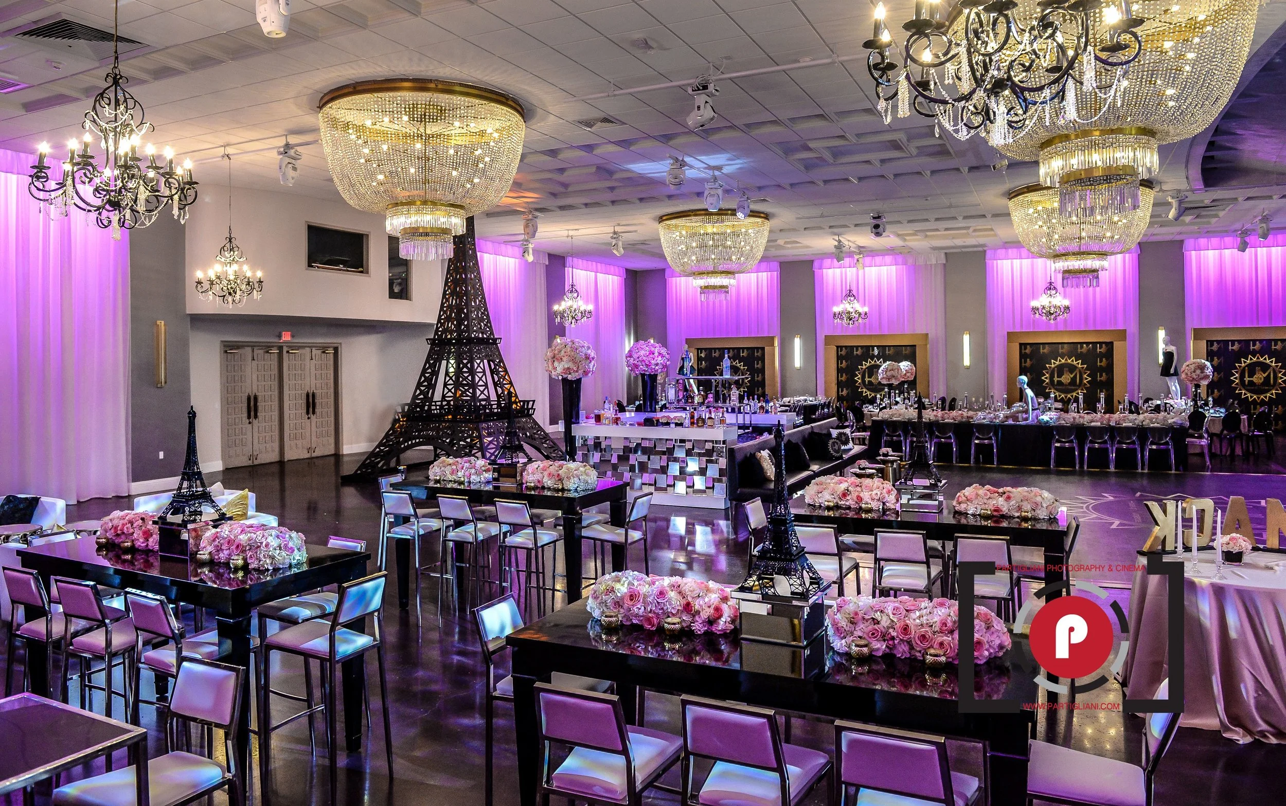 Elegant Quinceañera reception in a historic Miami Beach ballroom with dramatic chandeliers and surround lighting