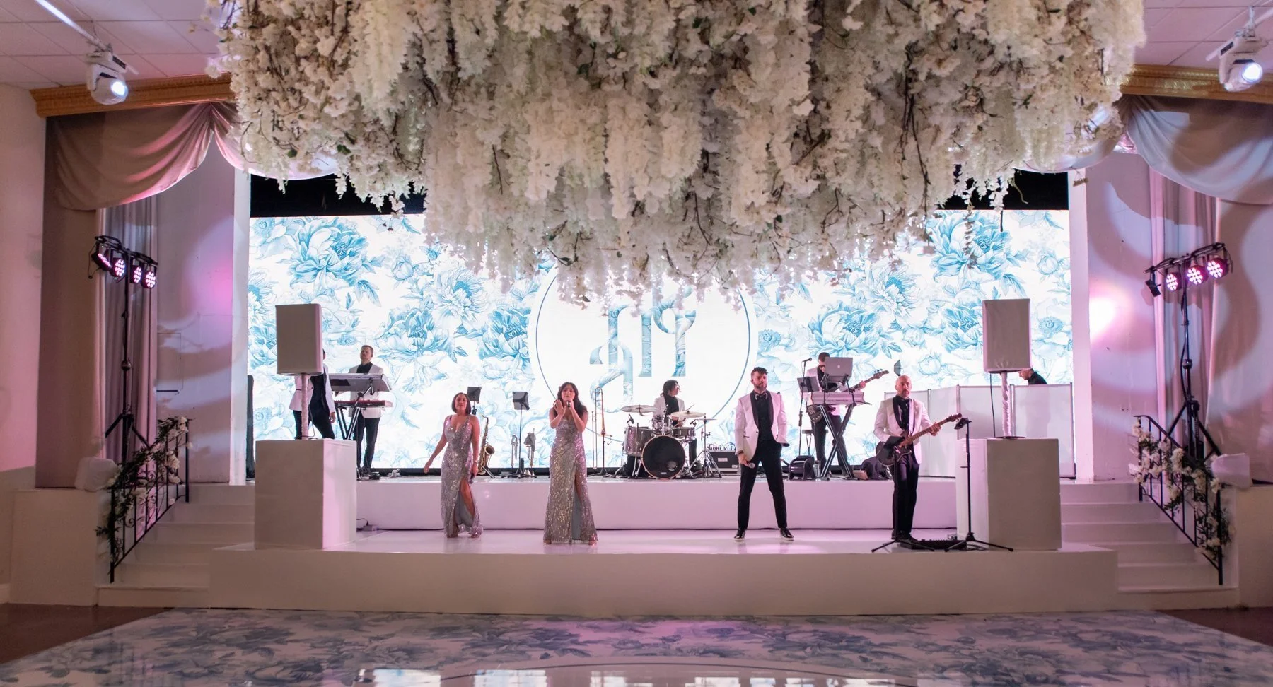 Wedding reception in Miami Beach ballroom featuring LED wall backdrop at Emanuel Luxury Venue