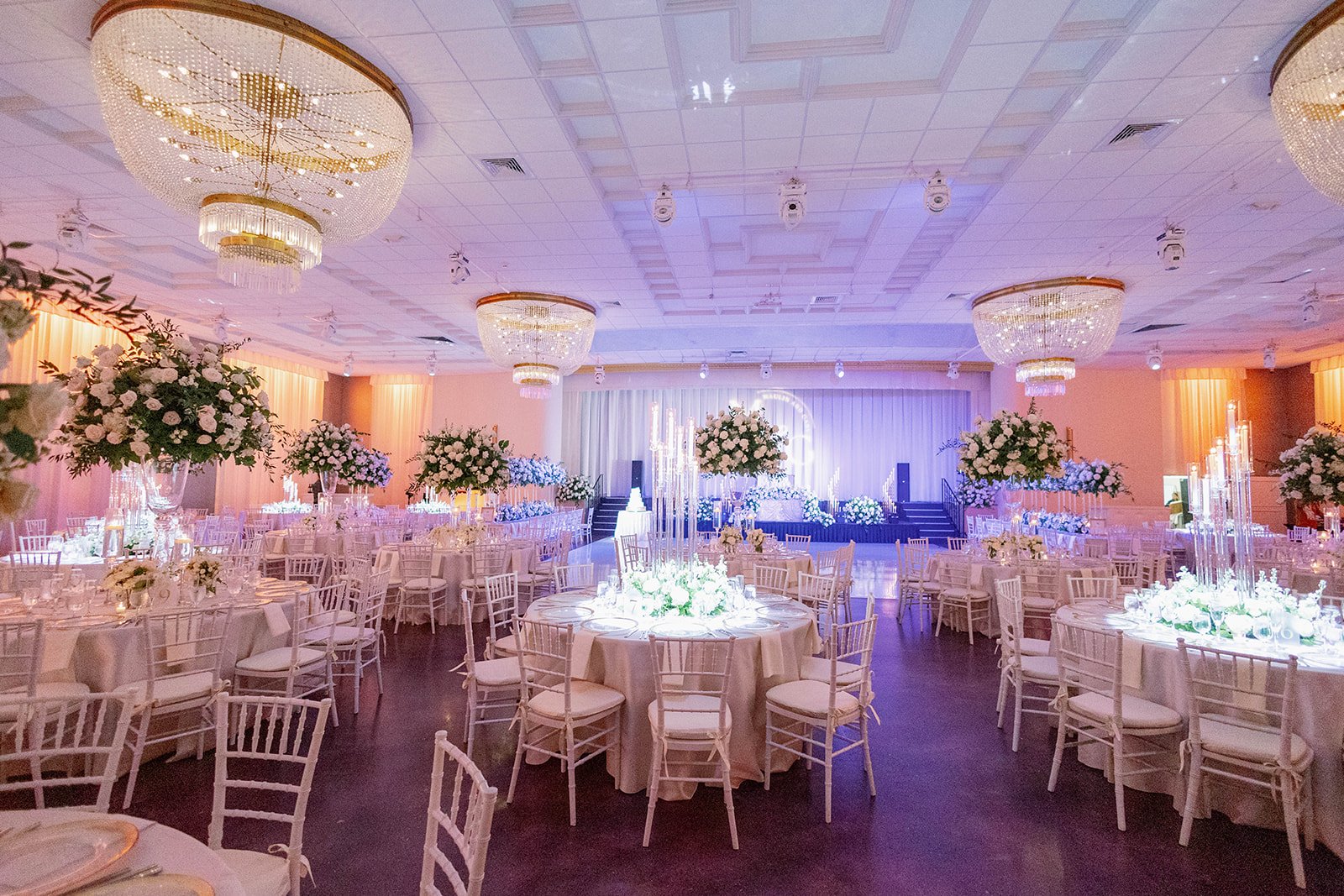 Crystal chandeliers illuminating the ballroom at Emanuel Luxury Venue in Miami Beach.