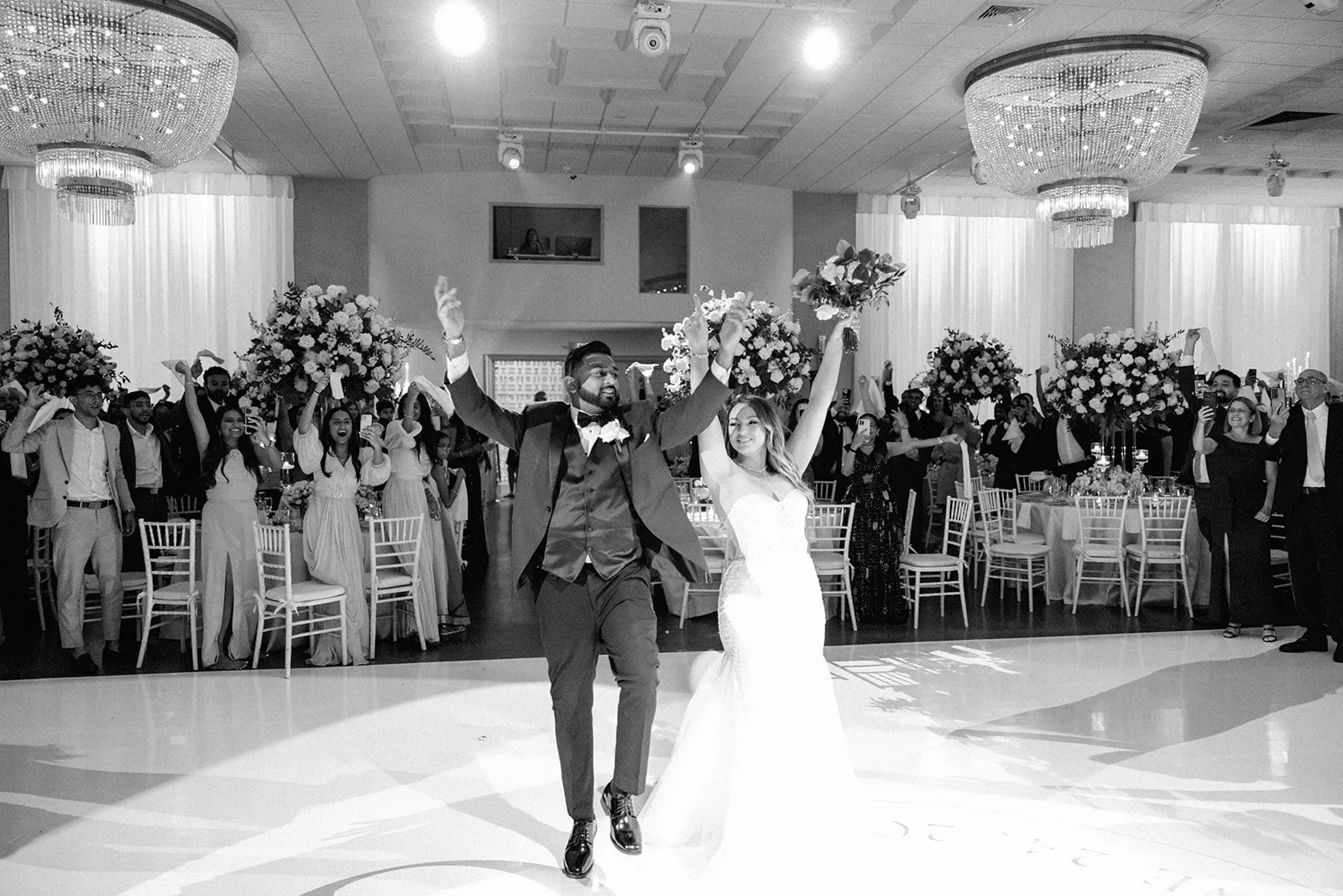 Bride and groom surrounded by luxury wedding decor inside a Miami Beach wedding venue ballroom.