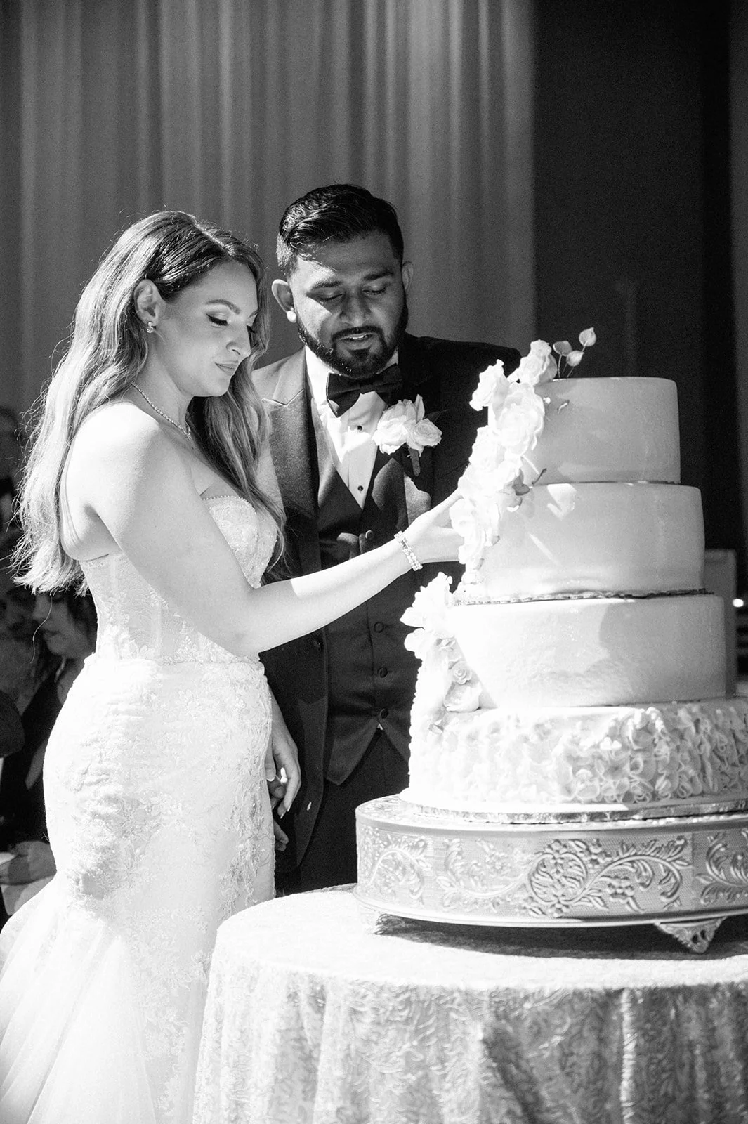Bride and groom surrounded by luxury wedding decor inside a Miami Beach wedding venue ballroom.