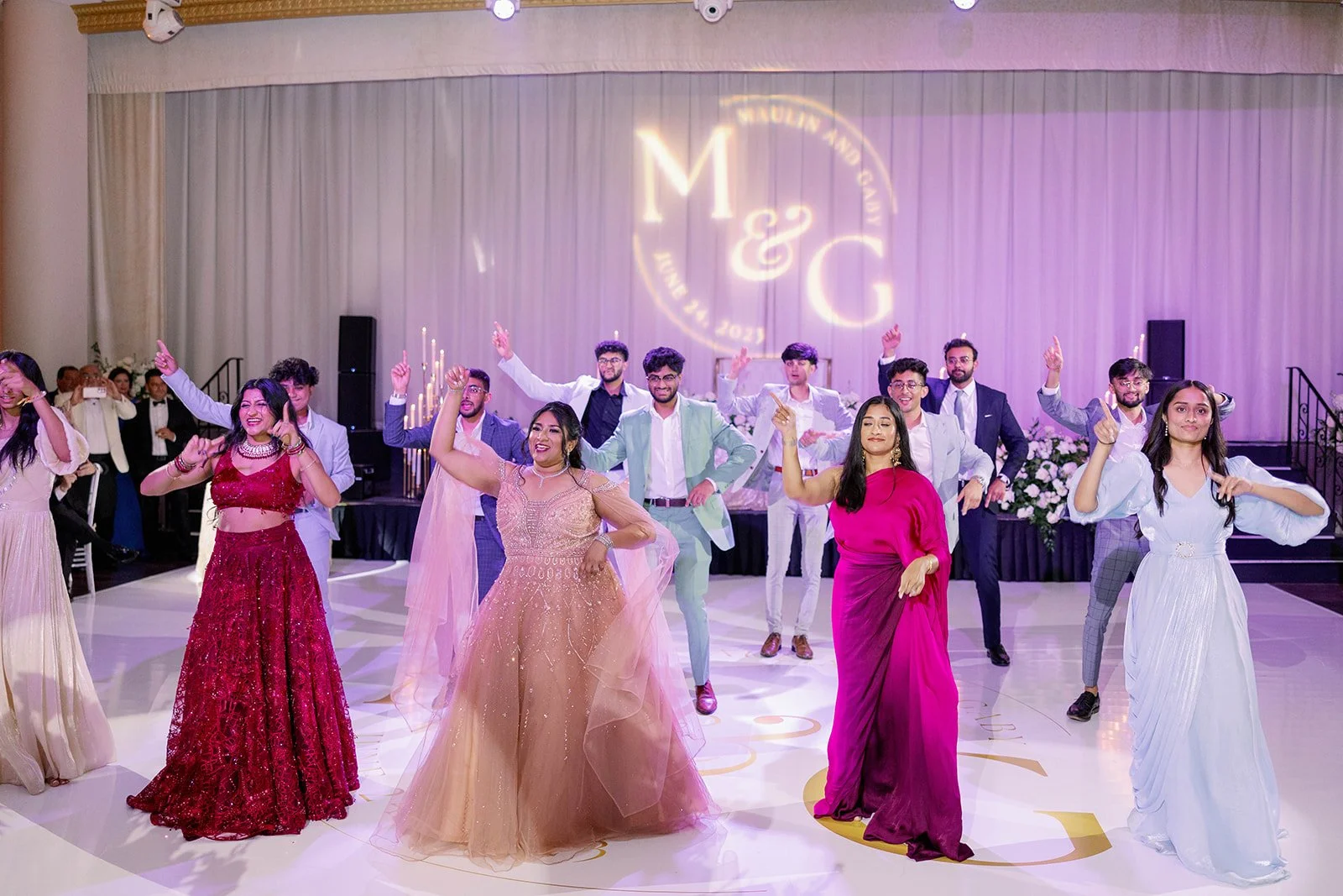Packed wedding dance floor with family and friends celebrating at a Miami Beach wedding venue.
