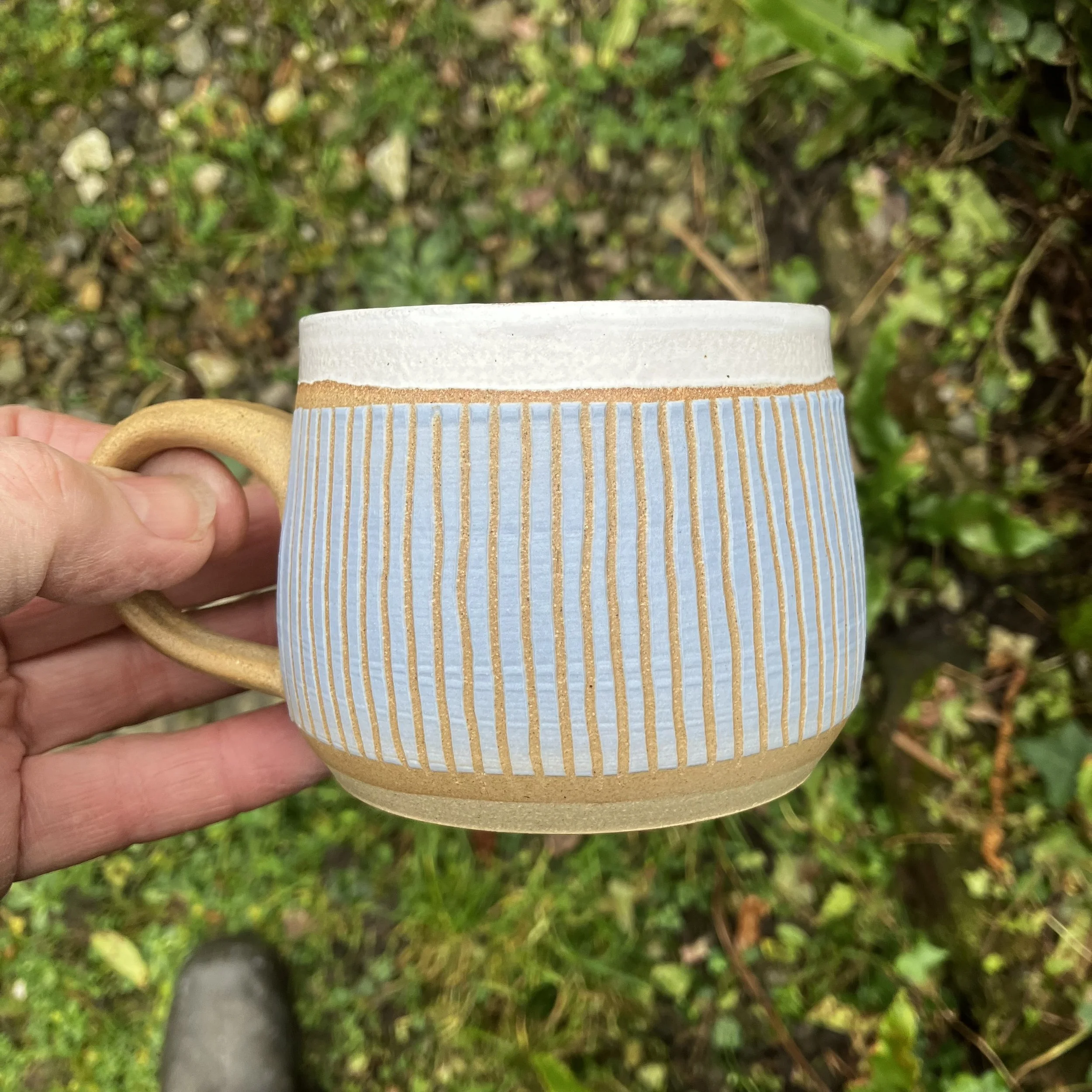1. Blue linear stoneware cup.