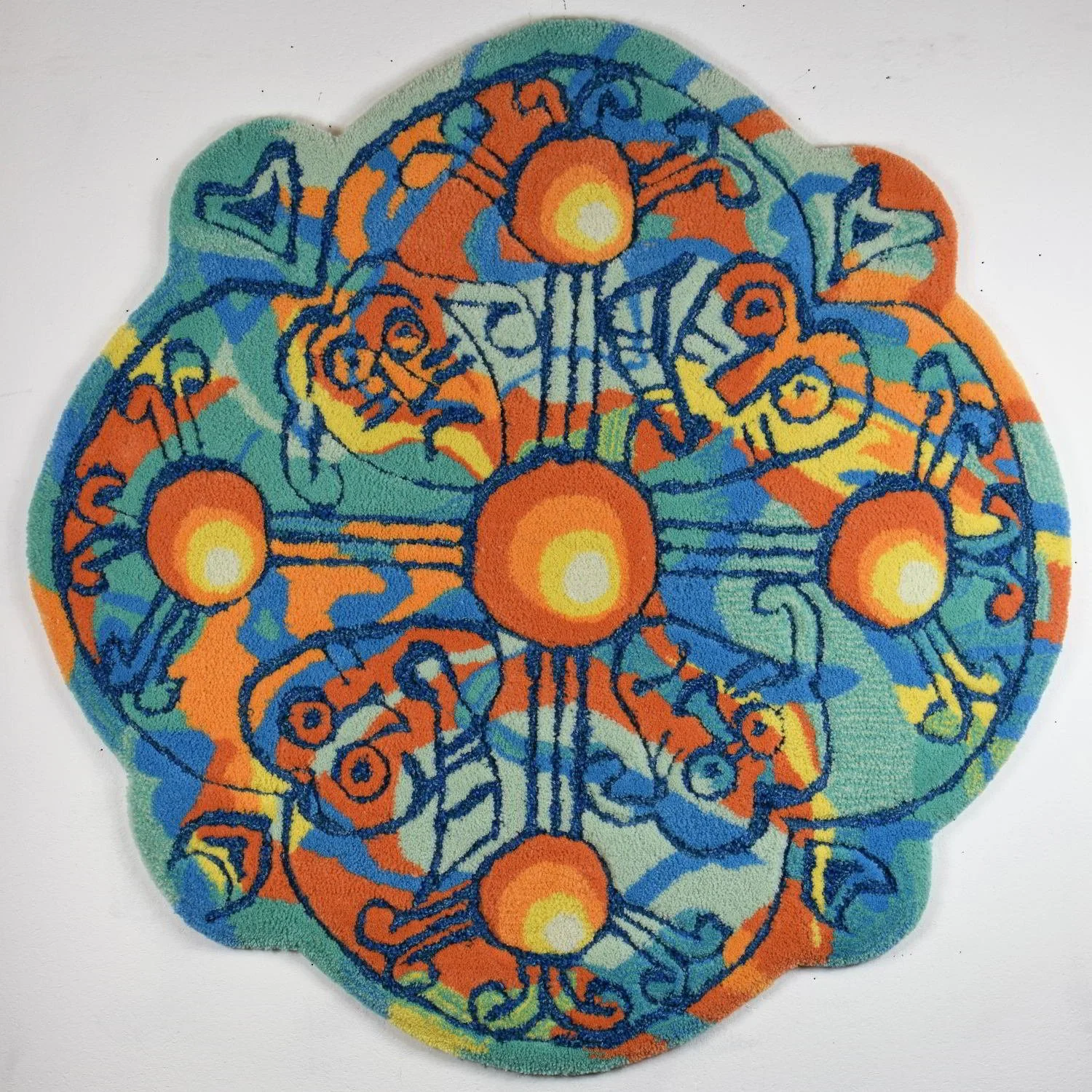 Colorful abstract rug with orange, yellow, blue, green, and black lines forming geometric and organic celtic faces shapes
