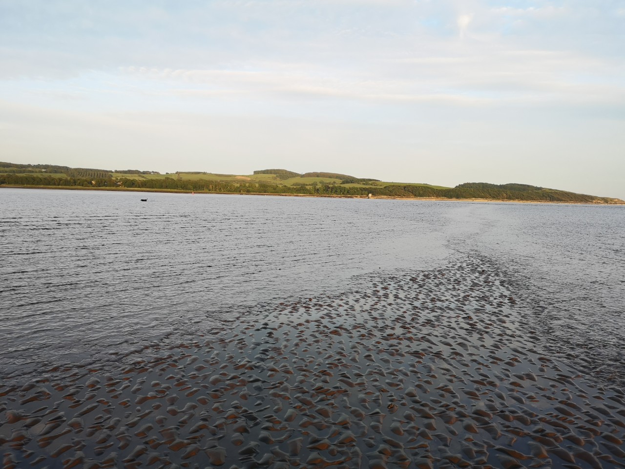 Tide coming in at Dhoon Bay Kirkcudbright with my dog fishing in the distance