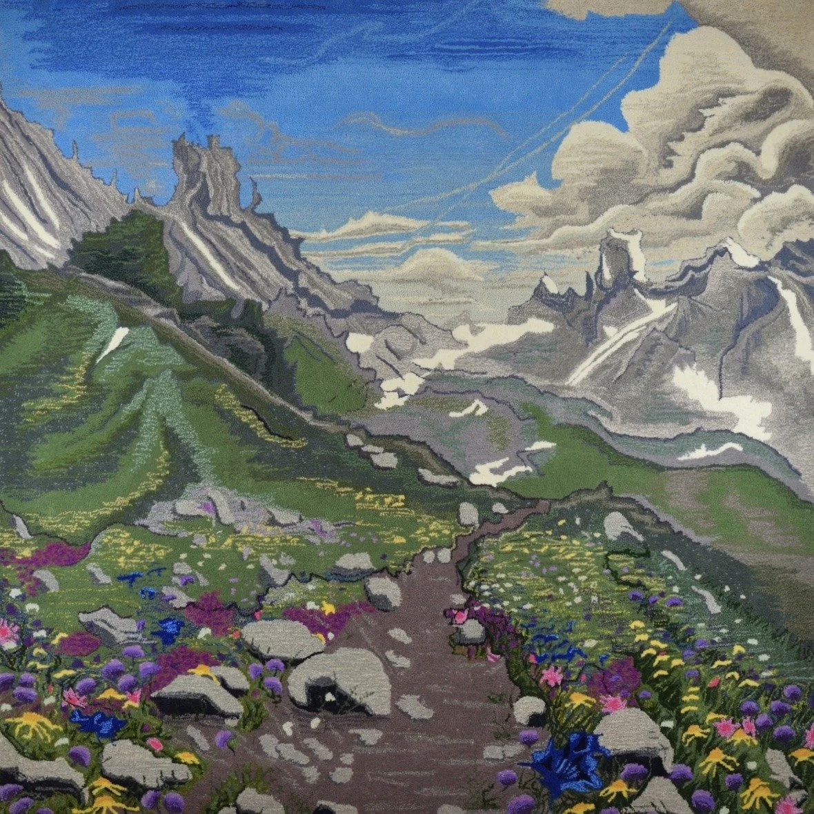 A hand tufted textile of a mountain landscape, Pierra Menta, with a clear blue sky, rocky mountains, green valley, and colorful flowers along a dirt path.