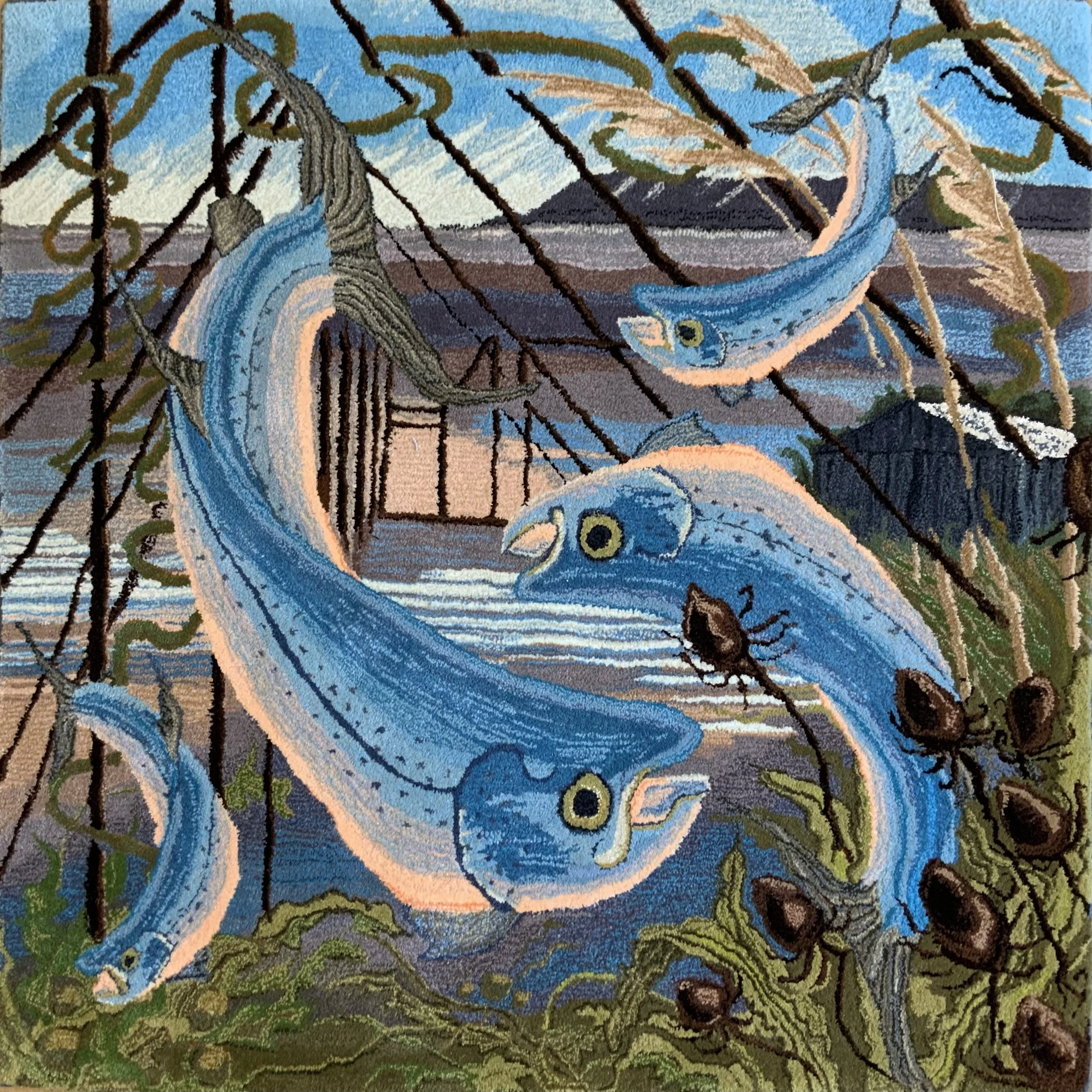 A textile artwork depicting salmon swimming among aquatic plants, with a coastline and mountains in the background, and teasles in the foreground.