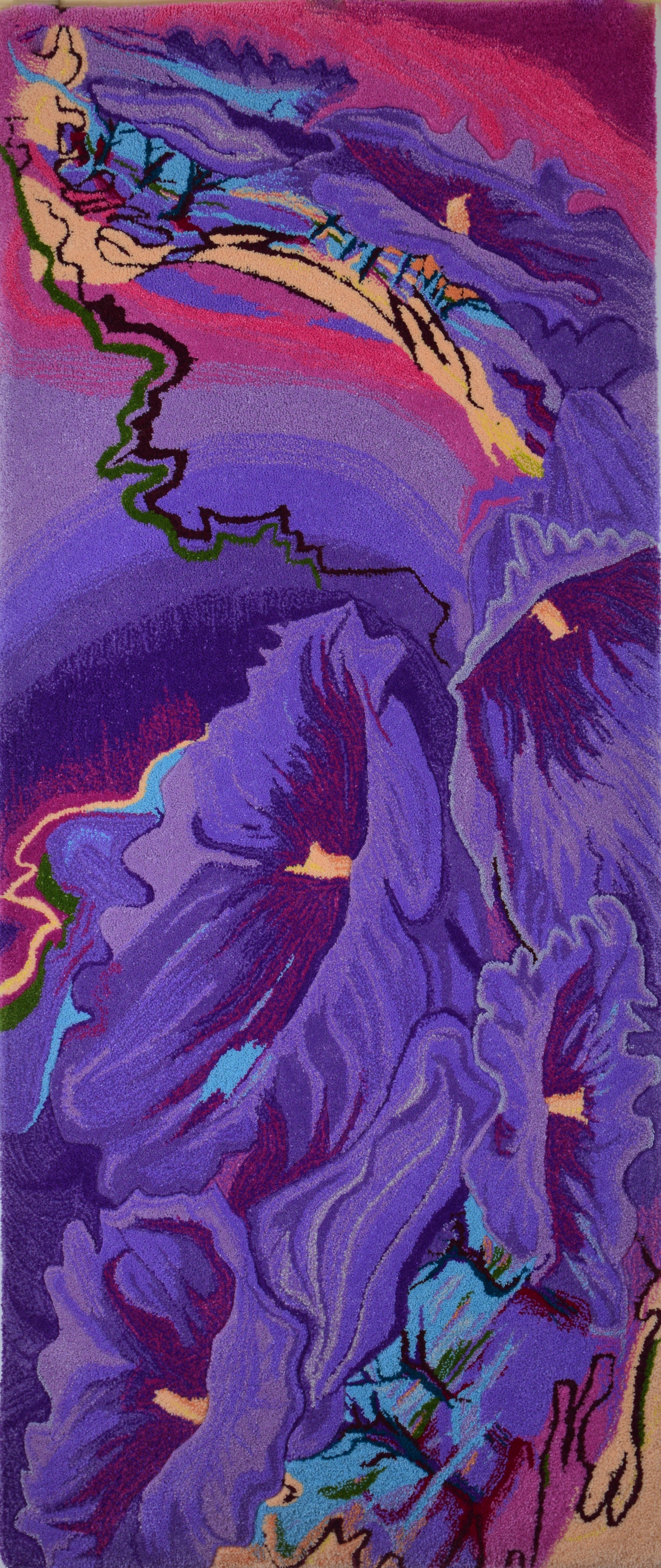 An abstract hand tufted rug featuring the vibrant purple, blue, pink, and green colors of the jacaranda tree with flowing and jagged shapes resembling floral patterns or landscapes.