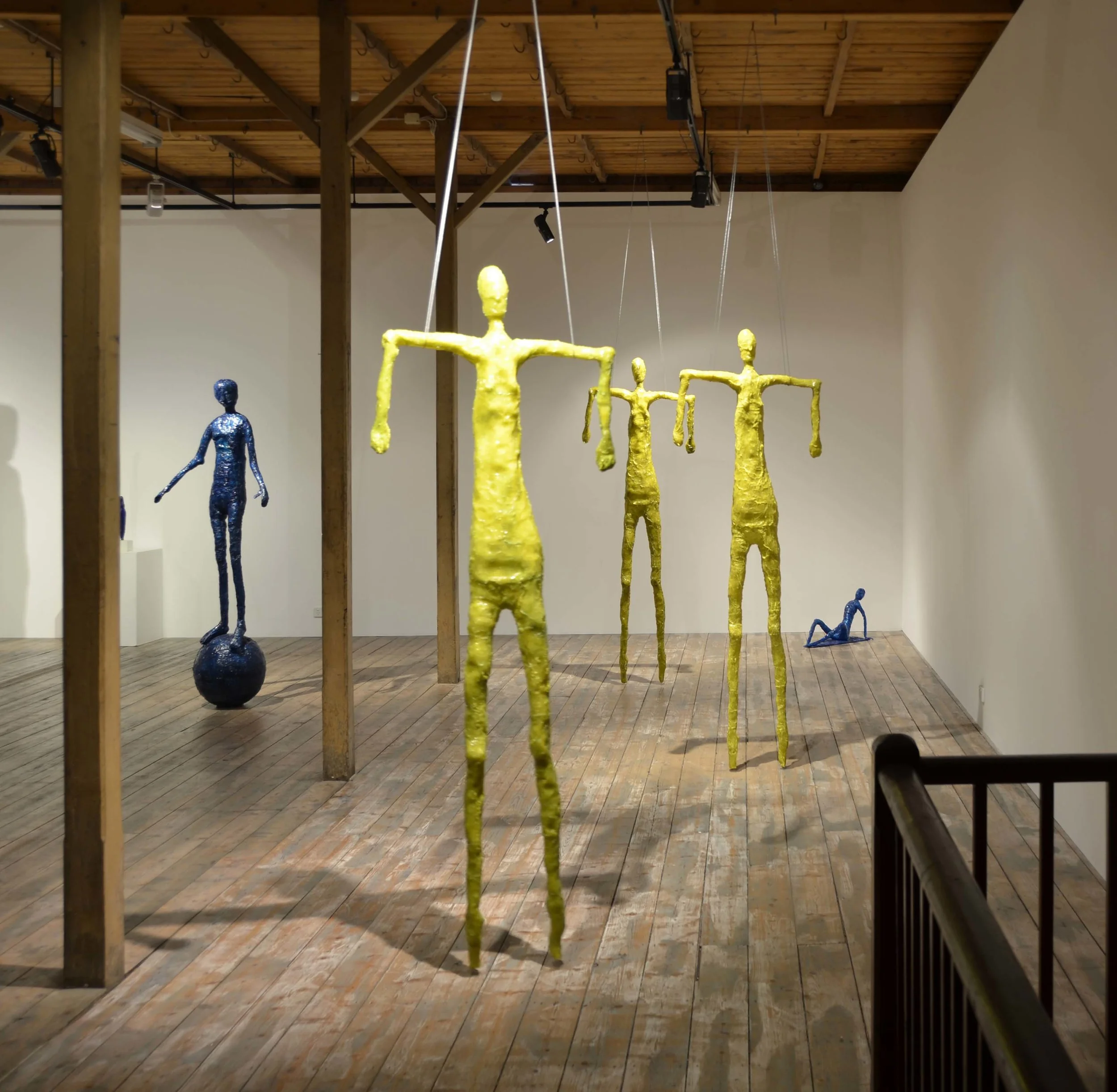 Elisabeth Weissensteiner,  Three Yellow Dancers Floating,  installation view, 2011, polyester resin, fibreglass and pigments, height 220cm each
