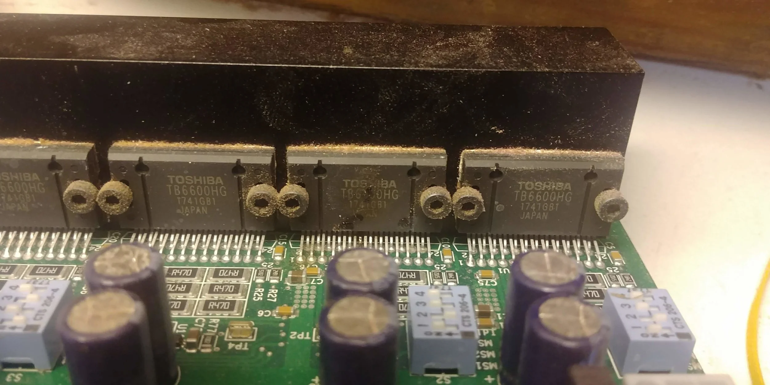 Check out the vertical black chip, second from right. See that brownish-black stain on it? That's a burn mark, presumably somehow caused by my separate controller sending power back to this board at the wrong time. Exactly what was the root cause, I never figured out. But I did figure out that this board is now fried.