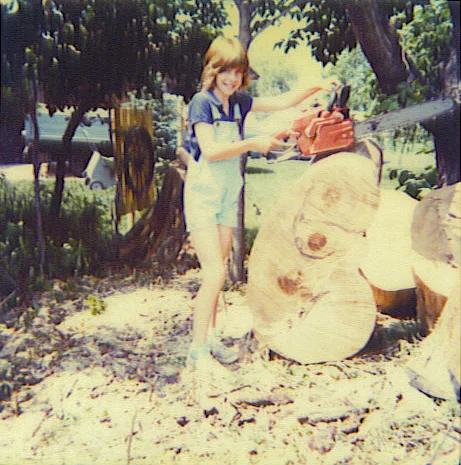 My dad loved to pose me with a saw and a freshly cut tree.