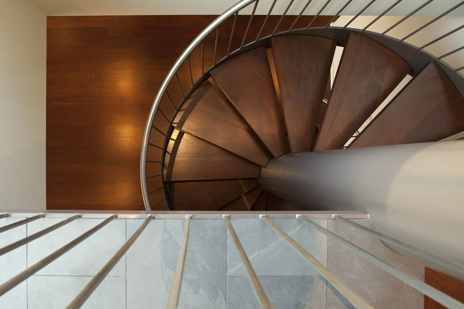 Penthouse renovation in San Francisco designed by Marin interior designer Studio SQUIRE featuring a Spiral Staircase, Wood Flooring, and Metal Railing .
