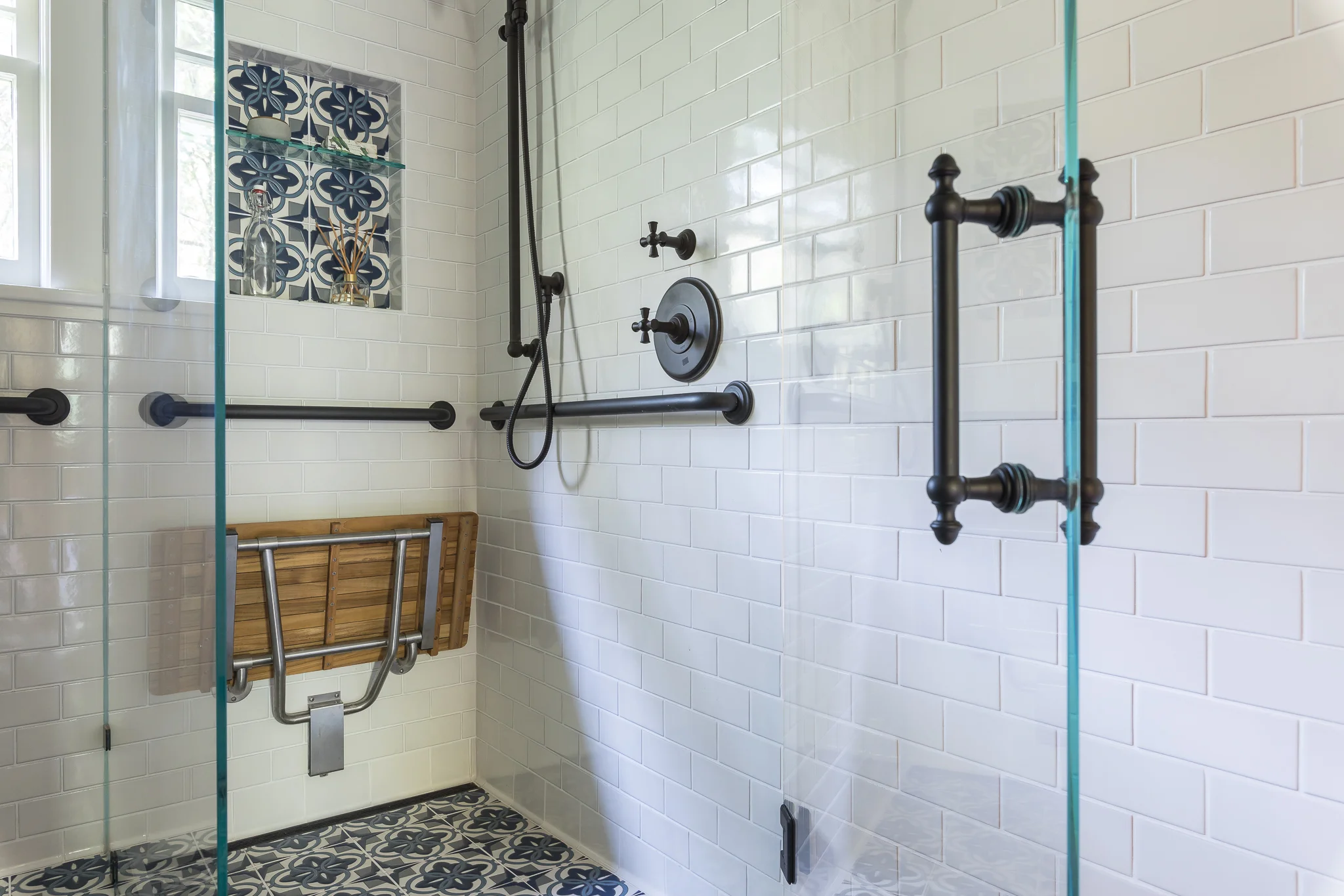 Bathroom renovation in Sausalito designed by Marin interior designer Studio SQUIRE featuring Moroccan Tile, Subway Tile, Black Fixtures, and Glass Shower