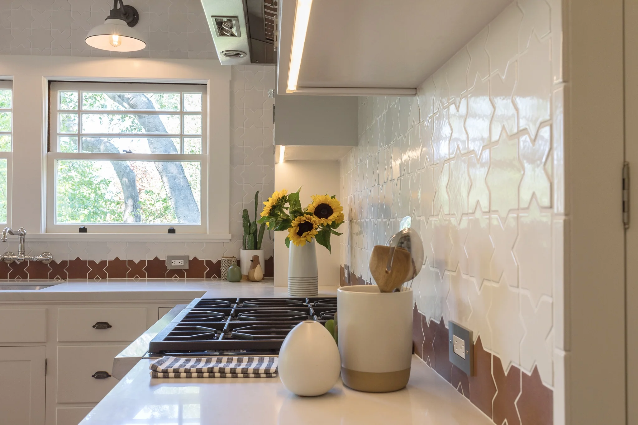 Kitchen renovation in Sausalito designed by Marin interior designer Studio SQUIRE featuring Moroccan Tile, Quartz Countertop, White Cabinets, and LED Undercabinet Lighting