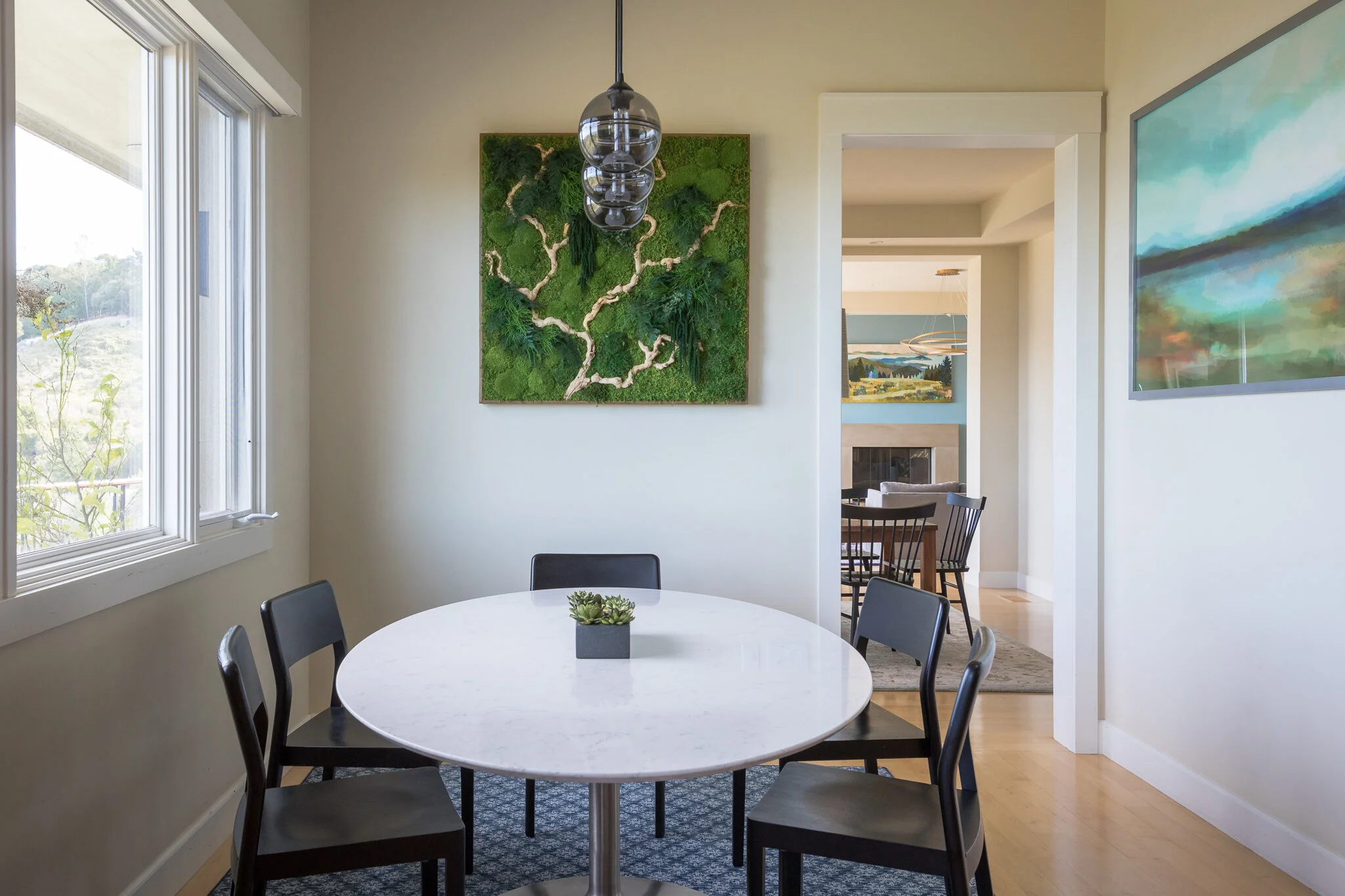 Kitchen renovation in Tiburon designed by Marin interior designer Studio SQUIRE featuring a modern breakfast nook with a custom preserved moss plant painting.