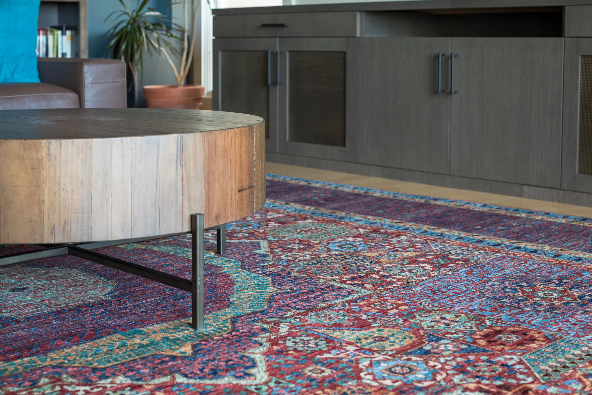 Living room renovation in Tiburon designed by Marin interior designer Studio SQUIRE featuring a gray stained wood media cabinet and a Persian area rug.