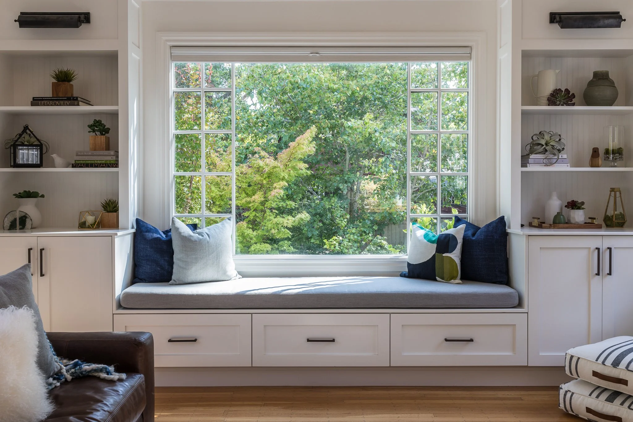 Modern living room design with window seat and custom built-in cabinets