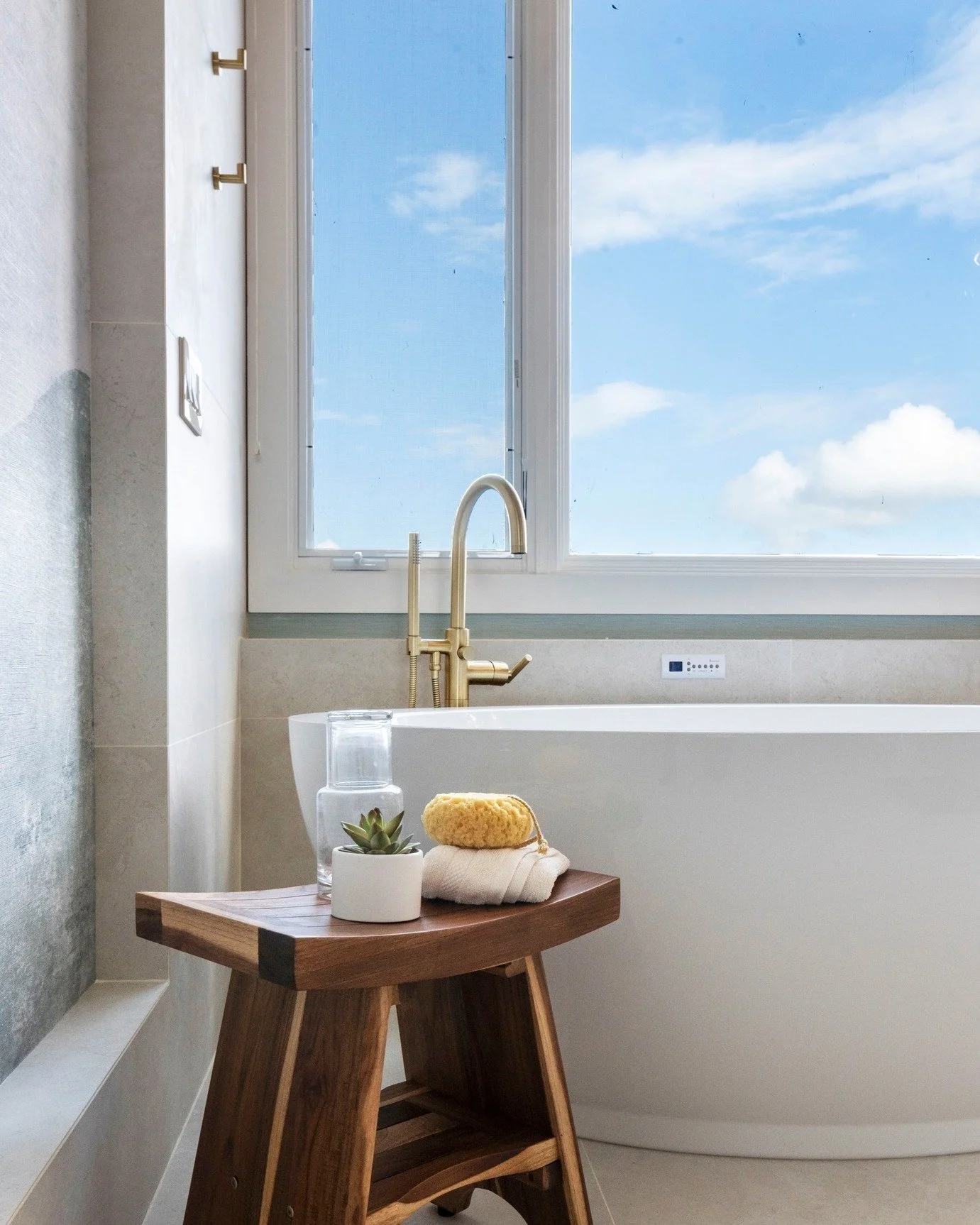 The ultimate soak isn&rsquo;t just a bath&hellip; it&rsquo;s an escape. This deep tub with a front-row seat to the Bay practically begs you to linger. Brass fixtures add a little sparkle, a wooden stool waits for your glass of wine, and those robe ho