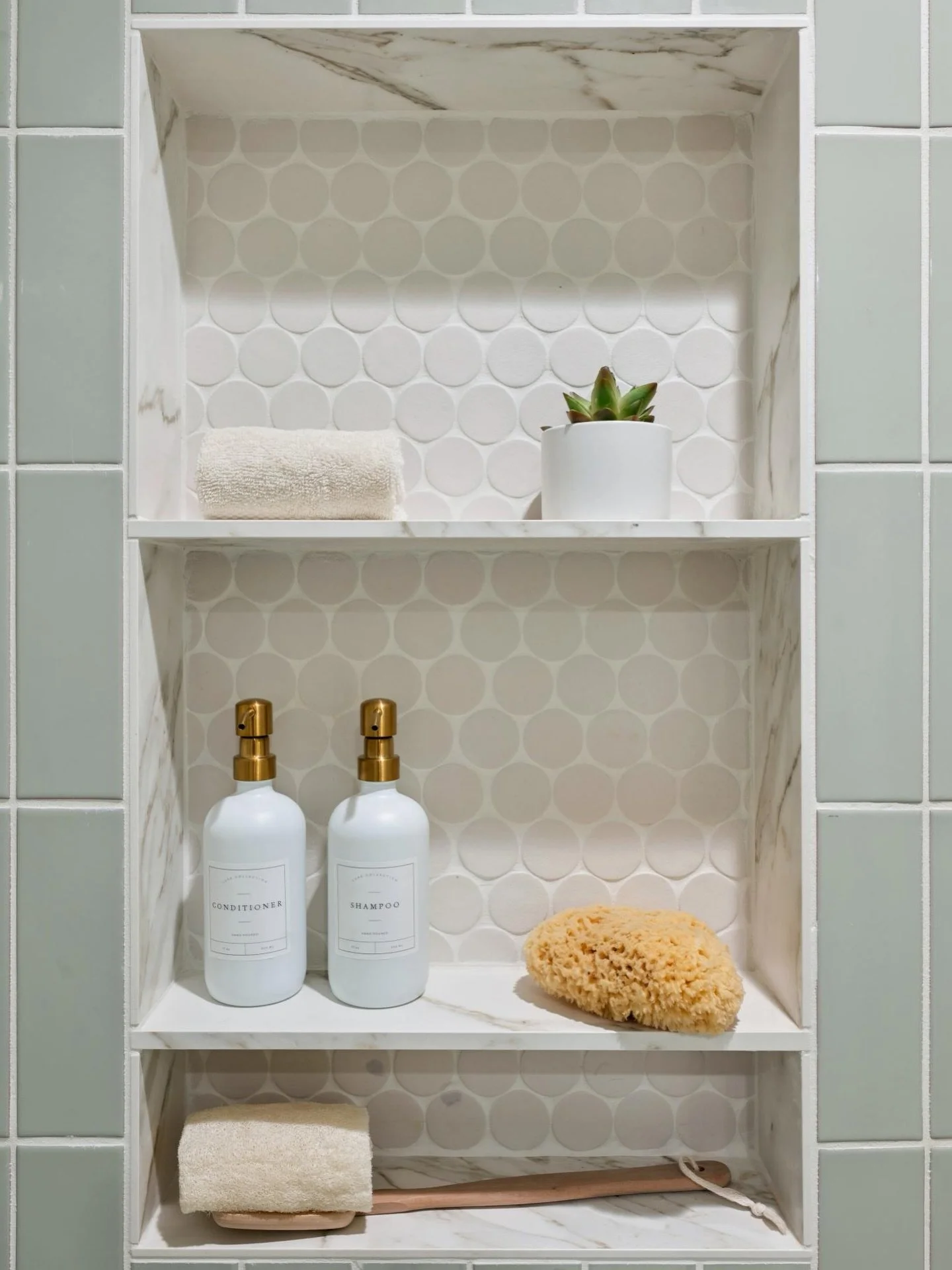 Designing a shower is one of our favorite opportunities to combine personality with practicality. If you have ever tried balancing shampoo bottles on the edge of a tub like a high stakes game of Jenga, you know storage matters.

That is why we love d