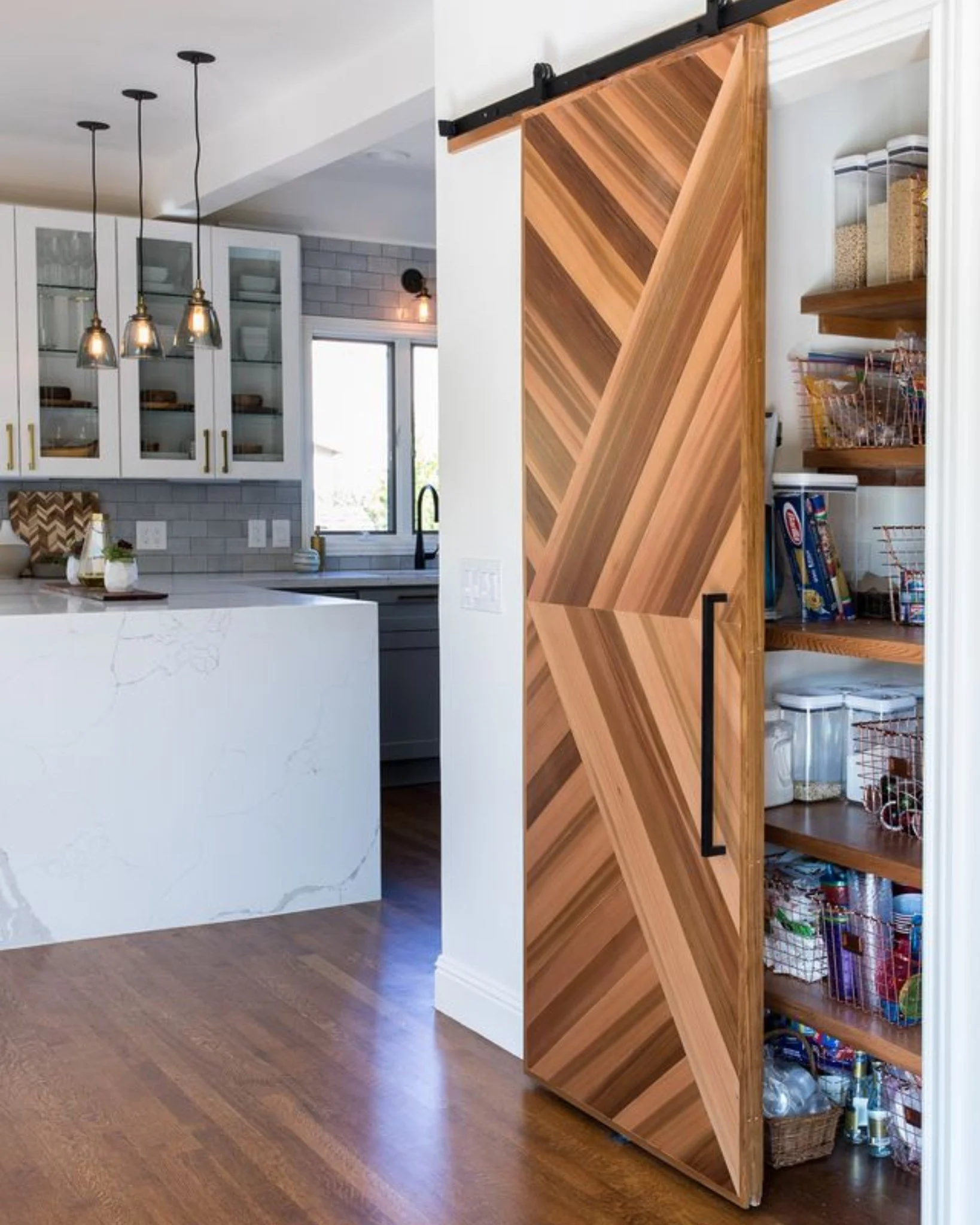 And suddenly, the pantry becomes your favorite spot in the house. 🤎

This sliding door keeps the pantry tucked away, adds a strong architectural detail, and brings in a ton of warmth through the wood variation and pattern.

It&rsquo;s functional, bu