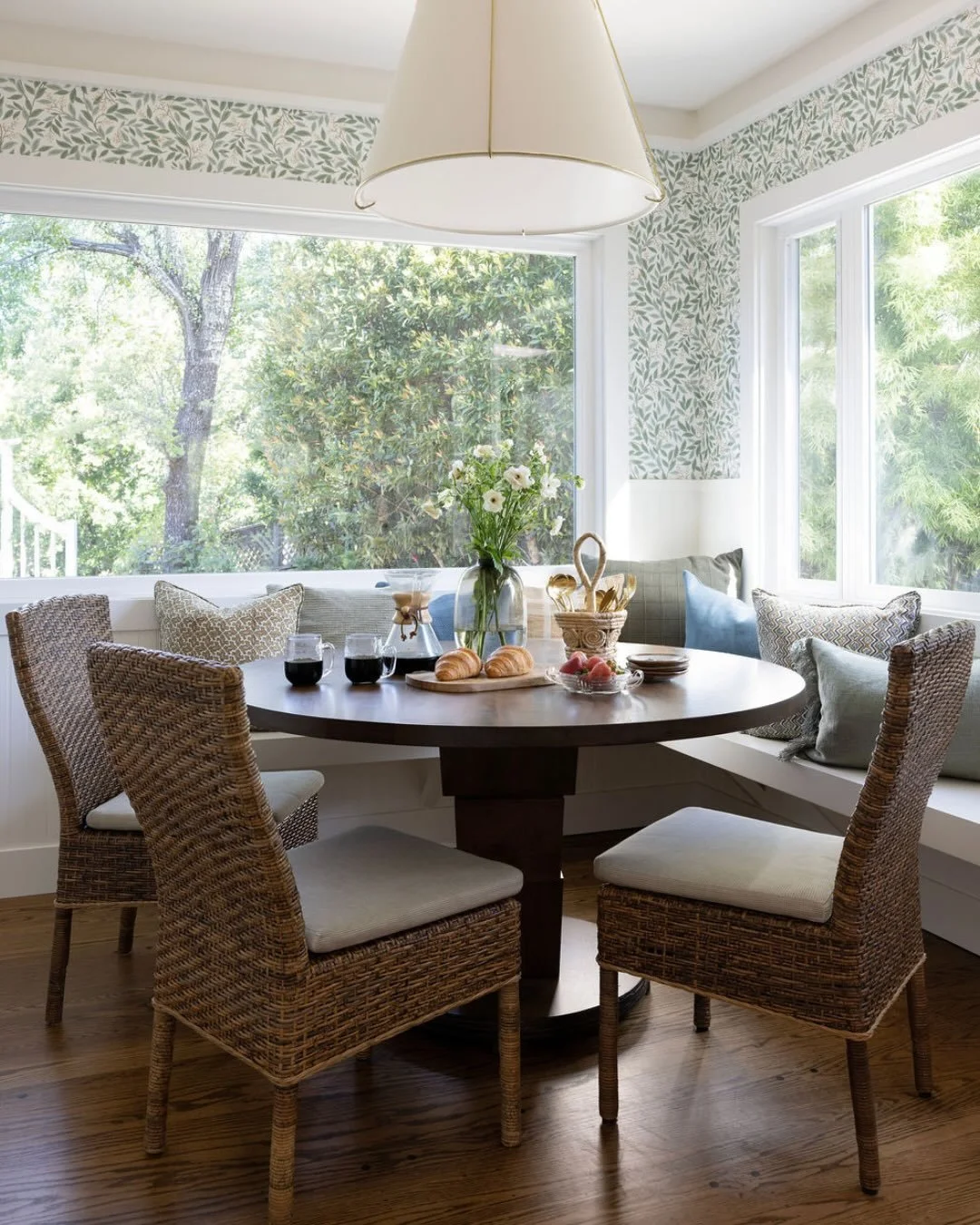 Soft green tones, creamy neutrals, and warm gold accents define a restrained material palette that feels both refined and quietly expressive. Natural light moves through the home throughout the day, softening edges and enhancing the subtle layering o