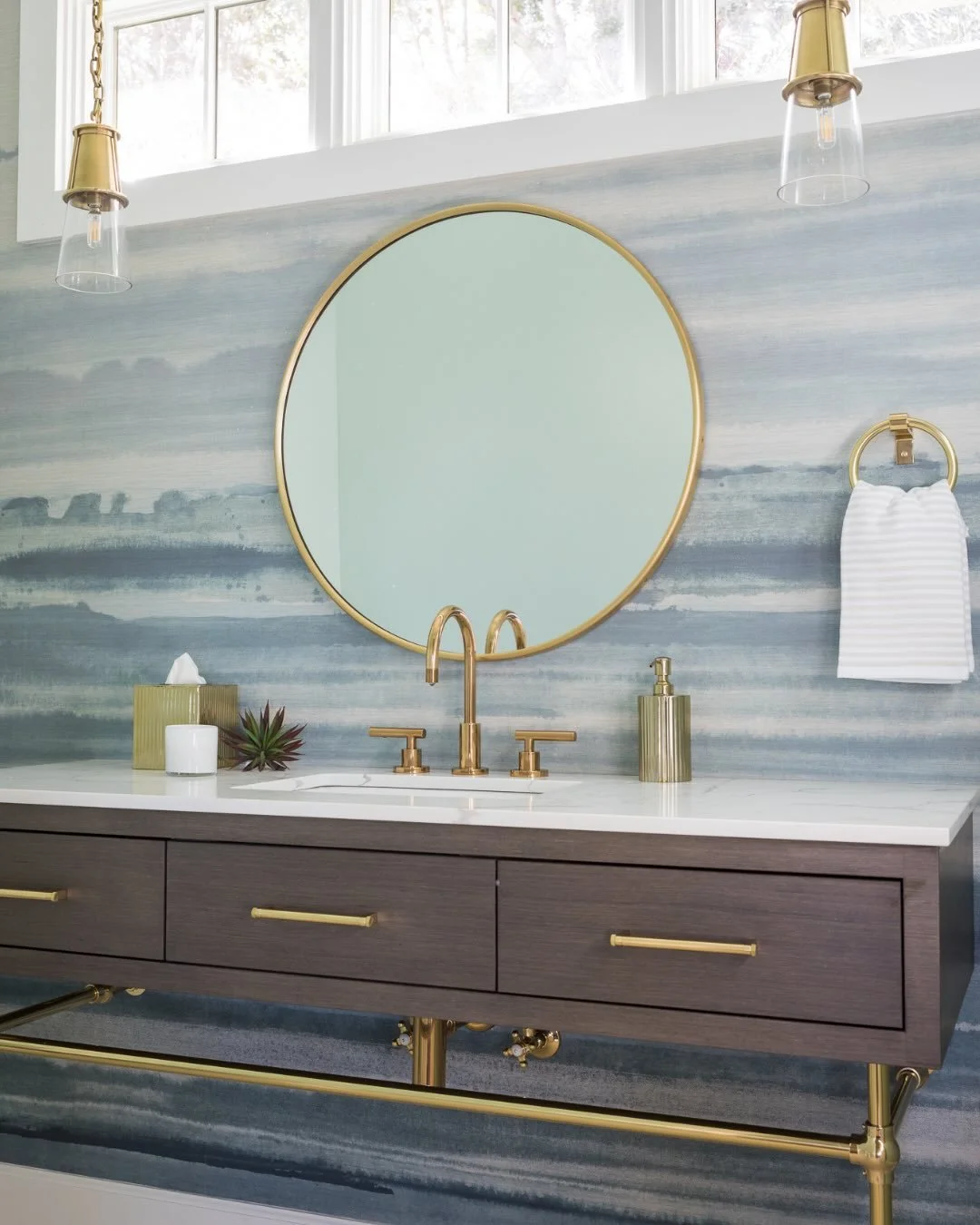 The beauty of a powder room is that it doesn&rsquo;t need to be large to make a statement.

This space layers texture, warmth and thoughtful detailing to create an experience that feels both elevated and inviting. A custom floating walnut vanity grou