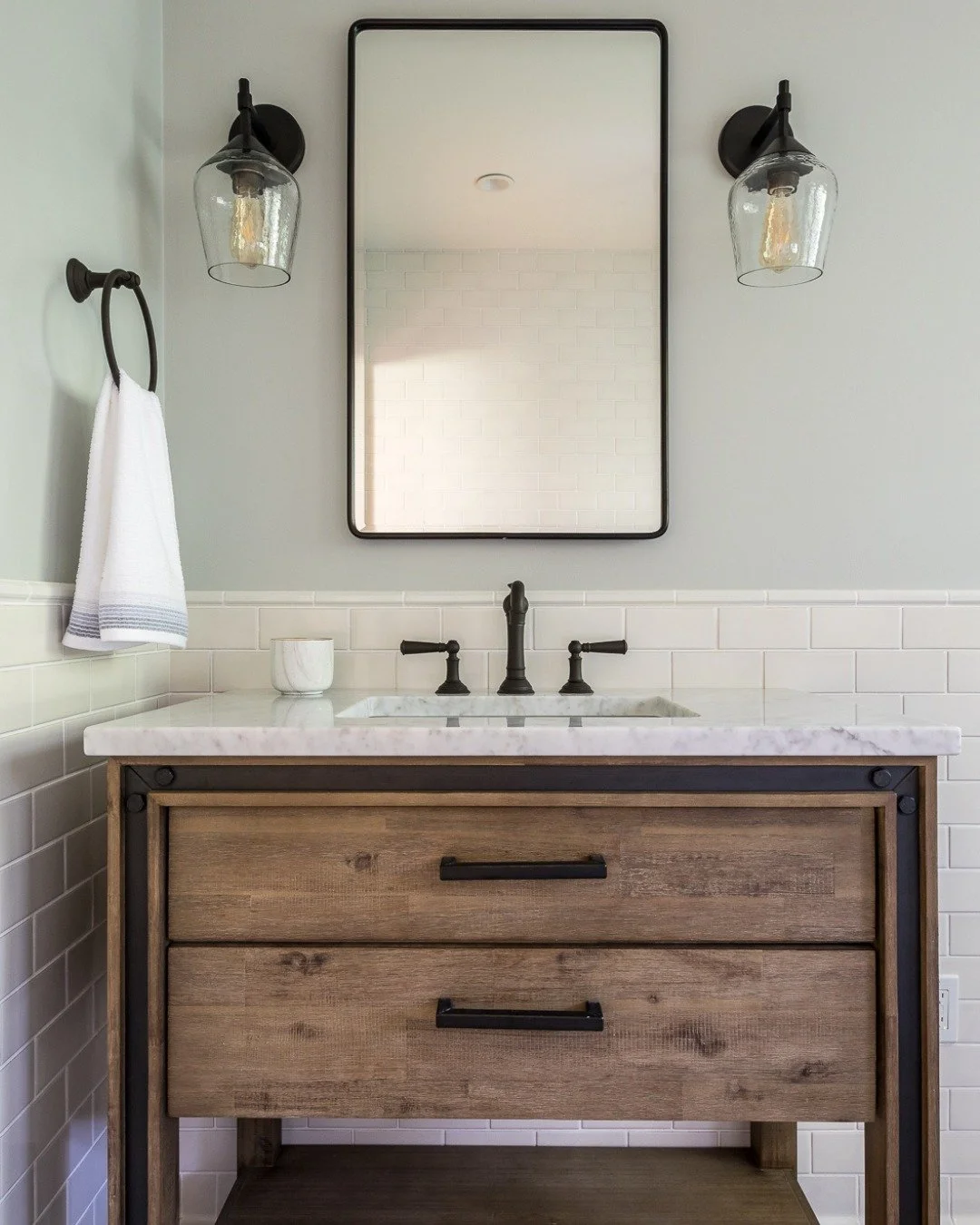 There is something quietly luxurious about a bathroom that feels both grounded and refined.

This space brings together classic subway tile with a bold, patterned floor - a moment of graphic contrast that sets the tone the second you walk in. Matte b