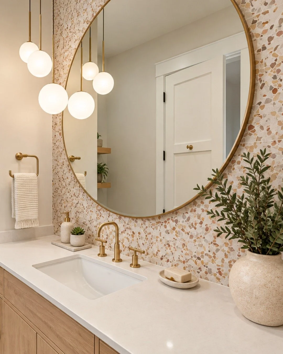 Three bathrooms. Three completely different personalities. Which one feels most like you?

1) Warm terrazzo, natural wood and brass details for a soft, organic look with a playful edge.

2) Soft blue-grey tile, natural wood cabinetry and brushed bras