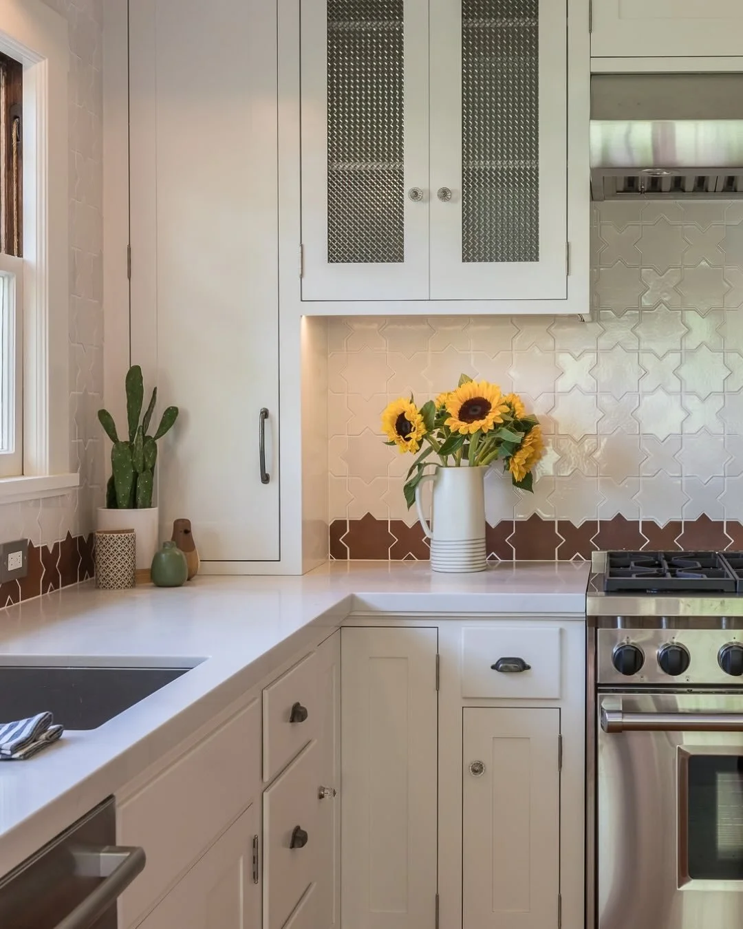 It&rsquo;s often the smallest details that give a kitchen its character.

At first glance, this space feels bright, calm and beautifully simple. Look a little closer, though, and there are layers of detail throughout. The geometric backsplash introdu