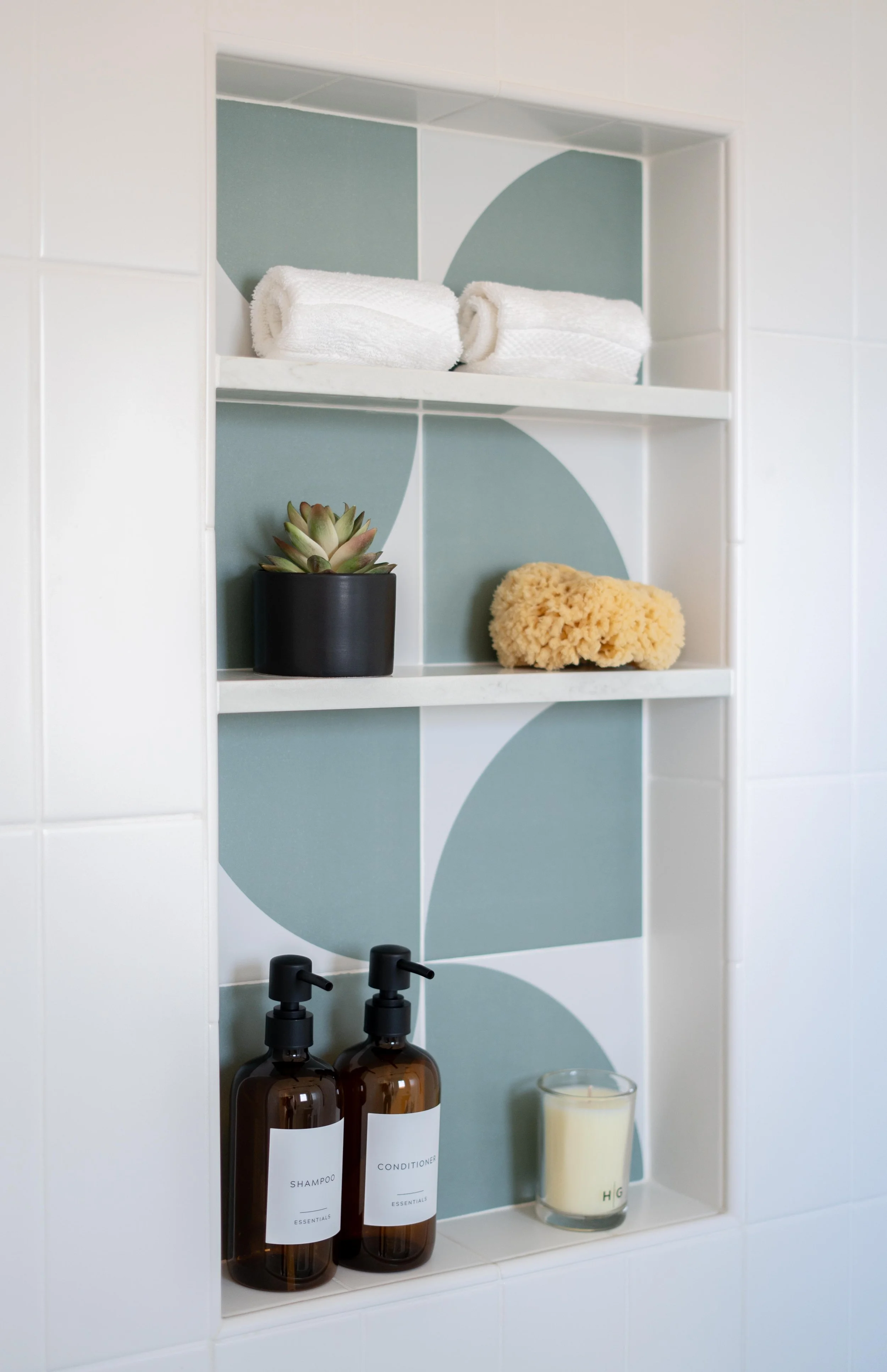 Kids bathroom renovation in Tiburon designed by Marin interior designer Studio SQUIRE featuring playful modern tile design in shower storage nook.