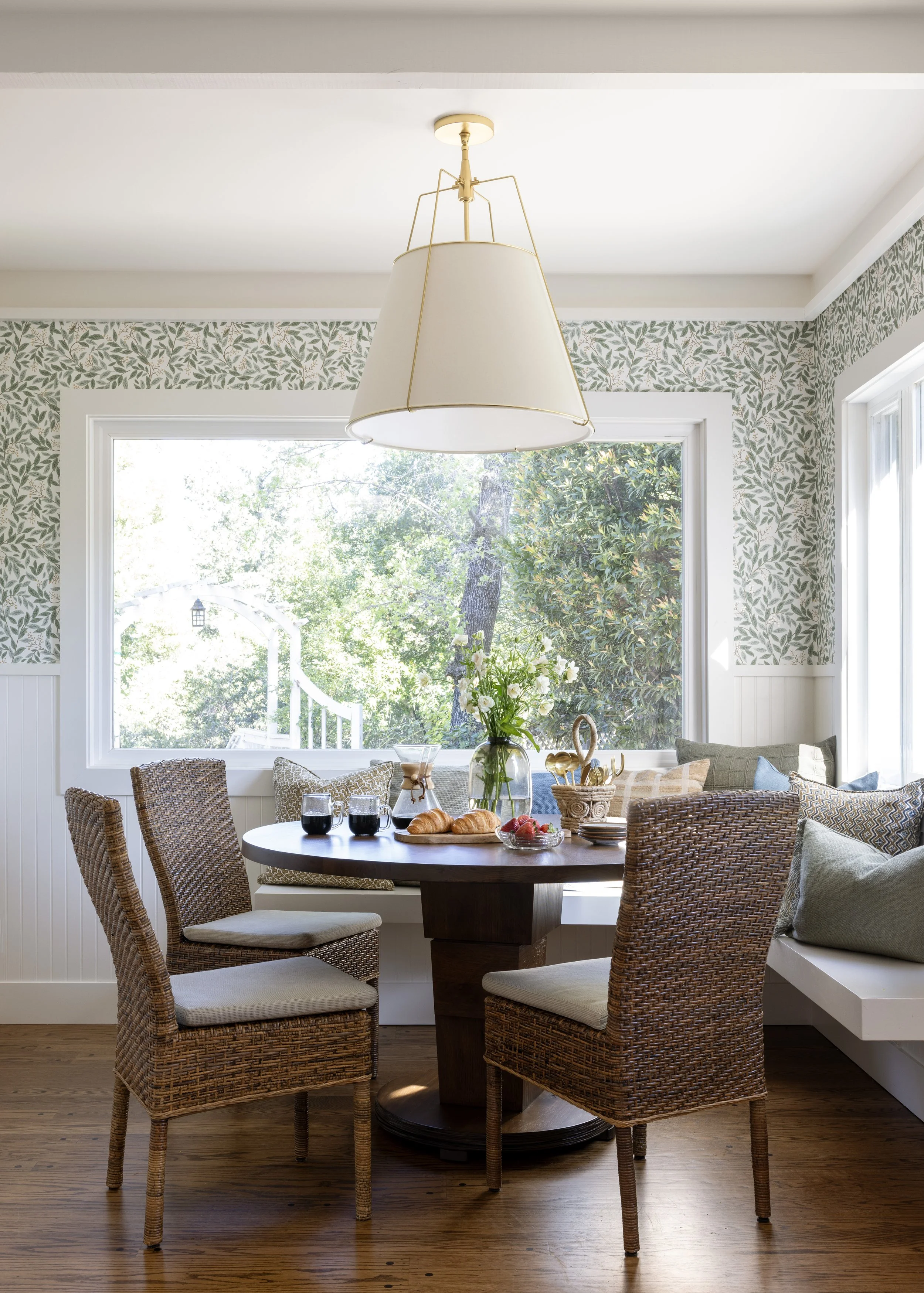 Kitchen renovation in Kentfield designed by Marin interior designer Studio SQUIRE featuring Walnut Wood Table, Wainscoting, Pillows, Brass Light Fixture, and Floral Wallpaper