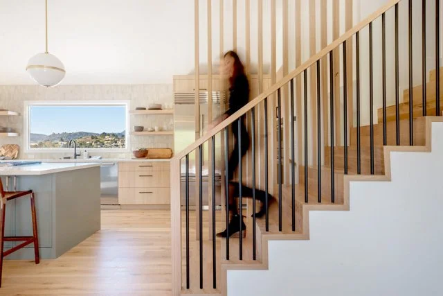 Whole home renovation in Belvedere-Tiburon designed by Marin interior designer Studio SQUIRE featuring custom white oak flooring, wood screen, and a modern stair design.