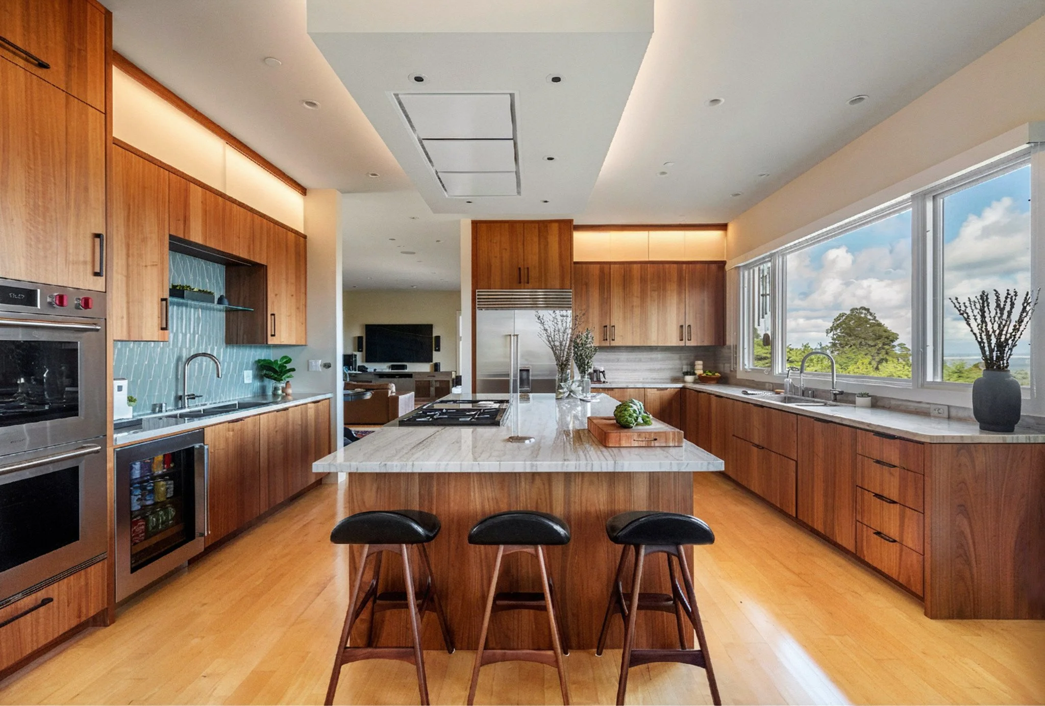 Luxury kitchen renovation in Belvedere-Tiburon designed by Marin interior designer Studio SQUIRE featuring walnut cabinets, matte black, cabinet hardware, quartzite countertops, Subzero Wolf appliances, and panoramic views of the San Francisco Bay.